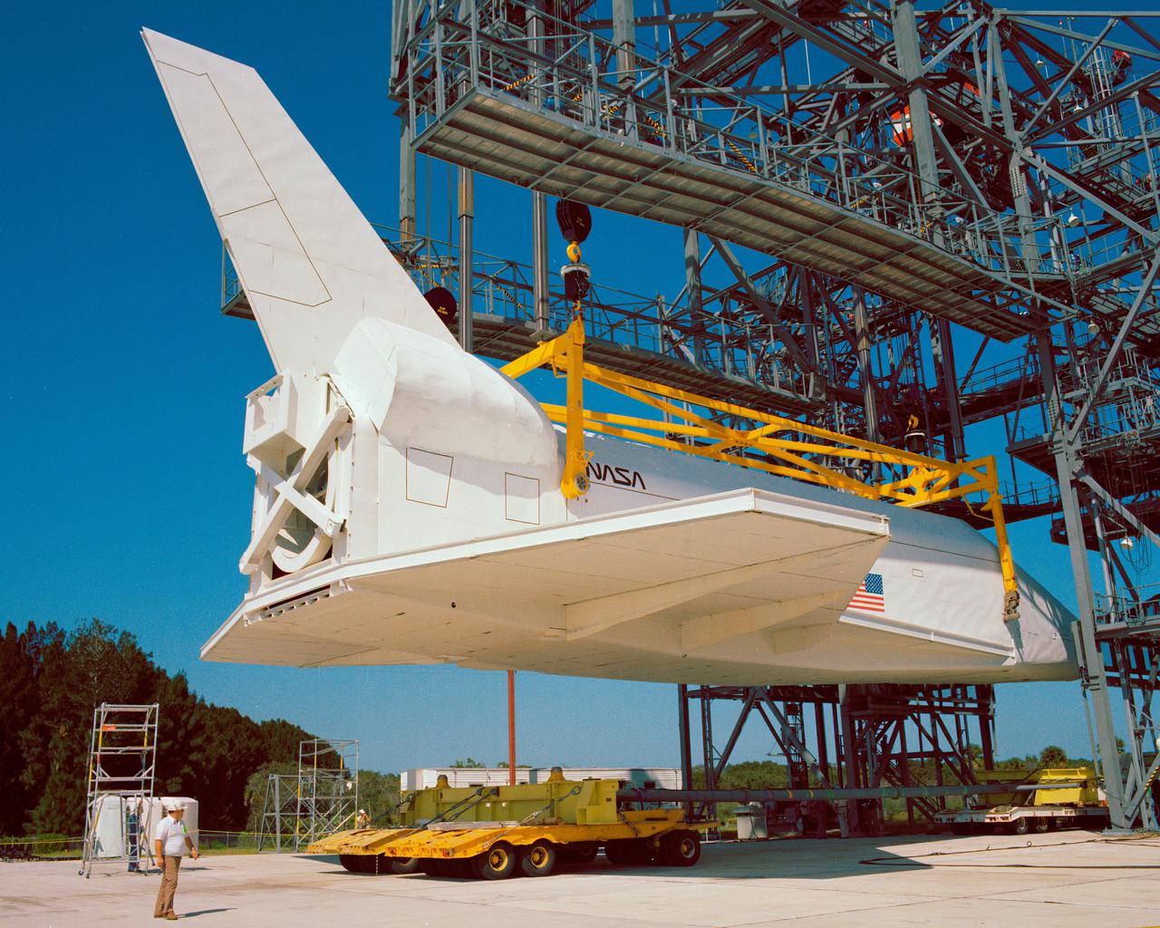 CAPE CANAVERAL, Fla. – At NASA's Kennedy Space Center in Florida, the space shuttle mock-up, dubbed Pathfinder, is attached to the Mate-Demate Device for at fit-check Oct. 19, 1978. The mock-up, constructed at NASA's Marshall Space Flight Center in Huntsville, Ala., possessed the general dimensions, weight and balance of a real space shuttle. It was shipped to Kennedy by barge and then used to fit-check the work platforms of the Mate-Demate Device, orbiter processing facilities and Vehicle Assembly Building, as well as support ground crew training. It also was used to rehearse post-landing procedures at Kennedy's Shuttle Landing Facility.  After being on display at the 'Great Space Shuttle Exposition' in Tokyo from June 1983 to August 1984, the mock-up returned to Marshall and now is on permanent display at the U.S. Space and Rocket Center near Huntsville. Photo credit: NASA