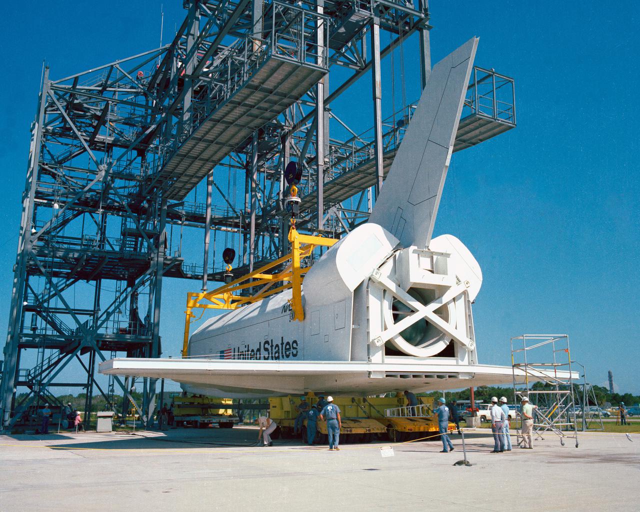 CAPE CANAVERAL, Fla. – At NASA's Kennedy Space Center in Florida, the space shuttle mock-up, dubbed Pathfinder, is attached to the Mate-Demate Device for at fit-check Oct. 19, 1978. The mock-up, constructed at NASA's Marshall Space Flight Center in Huntsville, Ala., possessed the general dimensions, weight and balance of a real space shuttle. It was shipped to Kennedy by barge and then used to fit-check the work platforms of the Mate-Demate Device, orbiter processing facilities and Vehicle Assembly Building, as well as support ground crew training. It also was used to rehearse post-landing procedures at Kennedy's Shuttle Landing Facility.  After being on display at the 'Great Space Shuttle Exposition' in Tokyo from June 1983 to August 1984, the mock-up returned to Marshall and now is on permanent display at the U.S. Space and Rocket Center near Huntsville. Photo credit: NASA