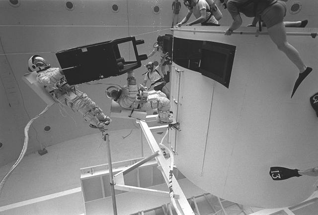 The Hubble Space Telescope (HST) is a cooperative program of the European Space Agency (ESA) and the National Aeronautical and Space Administration (NASA) to operate a long-lived space-based observatory. It was the first and flagship mission of NASA's Great Observatories program. The HST program began as an astronomical dream in the 1940s. During the 1970s and 1980s, the HST was finally designed and built and became operational in the 1990s. The HST was deployed into a low-Earth orbit on April 25, 1990 from the cargo bay of the Space Shuttle Discovery (STS-31). The design of the HST took into consideration its length of service and the necessity of repairs and equipment replacement by making the body modular. In doing so, subsequent shuttle missions could recover the HST, replace faulty or obsolete parts and be re-released. Pictured is MSFC's Neutral Buoyancy Simulator that served as the test center for shuttle astronauts training for Hubble related missions. Shown is an astronaut training on a mock-up of a modular section of the HST in the removal and replacement of scientific instruments.