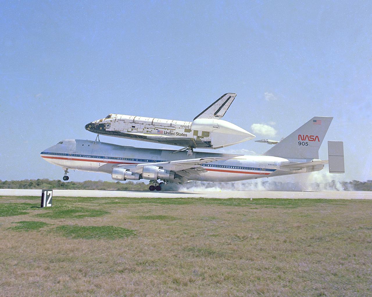KENNEDY SPACE CENTER, FLA. - The Space Shuttle Columbia, piggy-back on its 747 carrier aircraft, is only seconds away from a touchdown at Kennedy Space Center's Shuttle Landing Facility (SLF), completing its 2,400-mile ferry flight from Dryden Flight Research Center in California. Columbia, the first of the fleet of Space Shuttles, is scheduled for the first Space Shuttle flight n 1981.