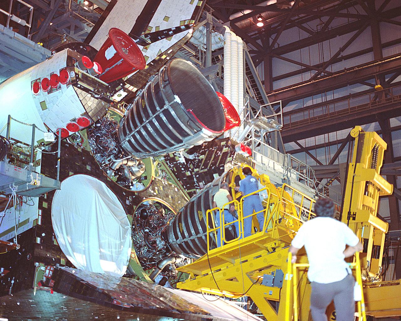 KENNEDY SPACE CENTER, FLA. - Space Shuttle main engines #1 and #3 being installed in Orbiter Columbia.