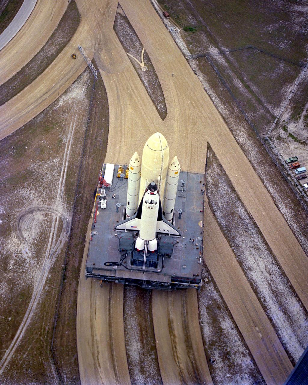KENNEDY SPACE CENTER, FLA. -  The first Space Shuttle vehicle destined to fly in space moves toward Pad A at Complex 39, where it will be launched.  The  STS-1 vehicle - consisting of America's first reusable spaceship, Columbia, the external propellant tank and twin solid rocket boosters - was assembled on a Mobile Launcher Platform in the Vehicle Assembly Building.  A six-million-pound tractor, called the Crawler-Transporter, is used to carry the Space Shuttle from the VAB to the launch pad, about 3.5 miles away.