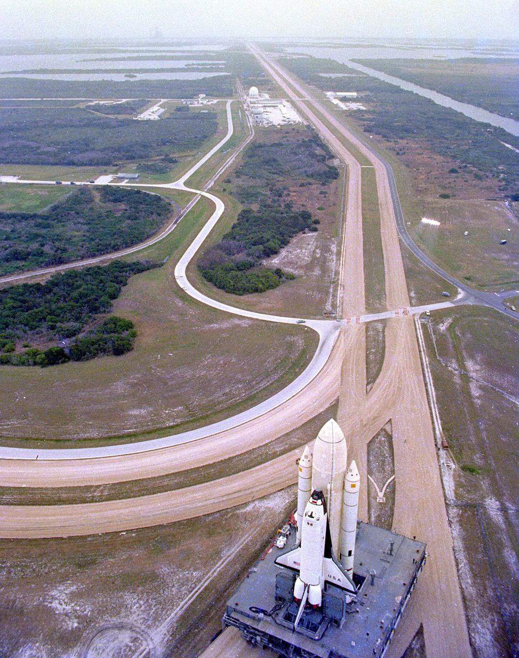 KENNEDY SPACE CENTER, FLA. -  The first Space Shuttle vehicle destined to fly in space moves toward Pad A at Complex 39, where it will be launched.  The STS-1 vehicle - consisting of America's first reusable spaceship, Columbia, the external propellant tank and twin solid rocket boosters - was assembled on a Mobile Launcher Platform in the Vehicle Assembly Building.  A six-million-pound tractor, called the Crawler-Transporter, is used to carry the Space Shuttle from the VAB to the launch pad, about 3.5 miles away.