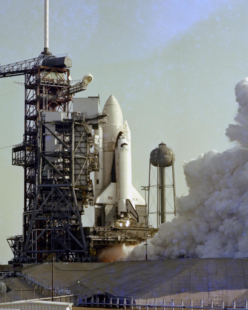 KENNEDY SPACE CENTER, FLA.  - Flames shoot from the nozzles of Space Shuttle Columbia's three main engines during the successful 20-second static firing which capped a formal rehearsal for the maiden flight of Columbia, scheduled for early April.  Remotely-operated cameras inside the pad perimeter snapped closeup views of the milestone event, which took place at 8:45 a.m. on February 20, 1981.  The three main engines reach 100 percent power -- over 1 million pounds of thrust -- during the test.  Hold-down bolts secured the vehicle to its mobile launcher platform.
