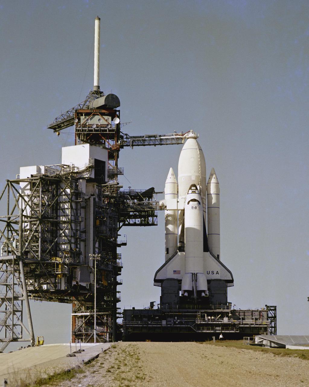 KENNEDY SPACE CENTER, FLA. - America's Space Shuttle stands poised on Launch Pad 39A, ready for Flight Readiness Firing of the main engines of the orbiter Columbia. The Rotating Service Structure has been retracted in this view, moving the 'White Room' access to the Cargo Bay and other support facilities away from the exhaust damage zone. This view was taken from the base of the approach ramp used by the Crawler when the Shuttle and its Mobile Launch Platform are moved from the Vehicle Assembly Building to the Pad.