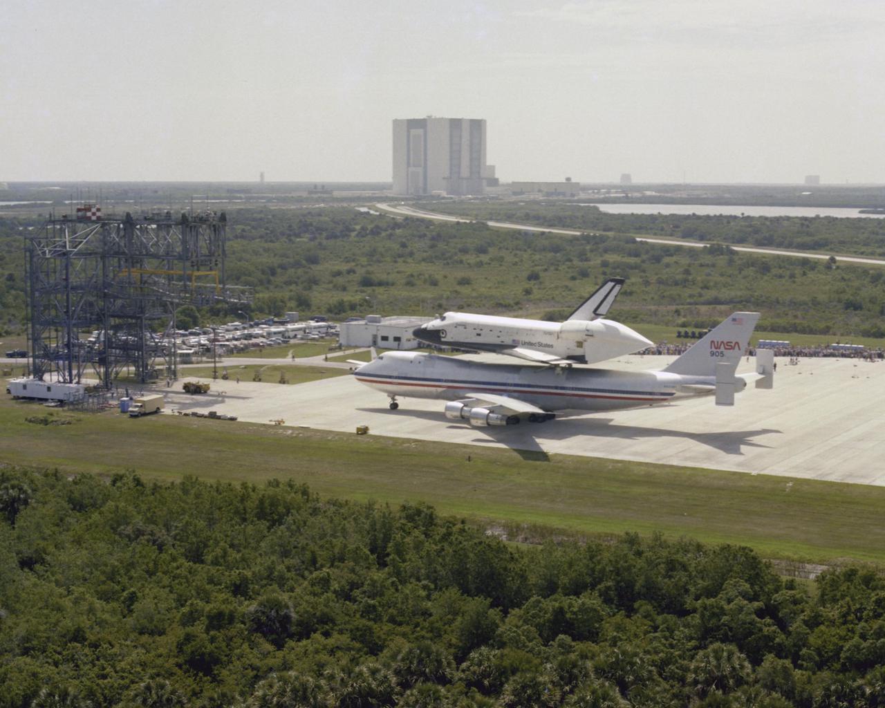 KENNEDY SPACE CENTER, FLA. - The Space Shuttle Orbiter Columbia - riding piggy back atop a modified 747 jet called the Shuttle Carrier Aircraft - arrives at Kennedy Space Center after a two-day journey from the Dryden Flight Research Center in California. Welcomed home by a crowd of KSC employees and their families and guests, Columbia touched down on the Shuttle Landing Facility at 11:23 a.m. Tuesday, two weeks after its return to Earth from the first Space Shuttle flight into space. The orbiter and SCA are seen here parked in front of the Mate_Demate Device, where the orbiter will be hoisted off the 747.
