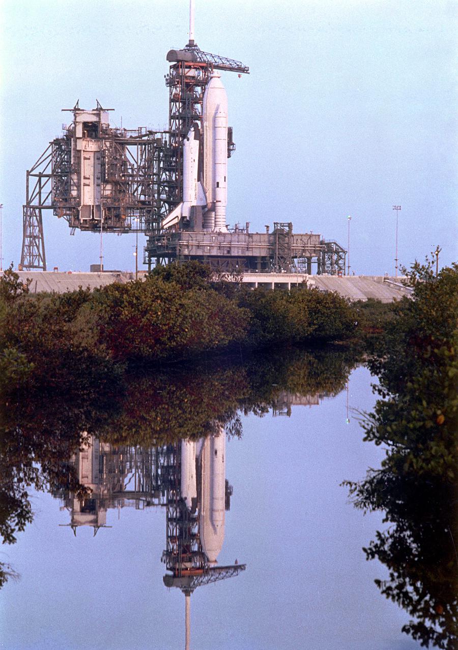 KENNEDY SPACE CENTER, FLA. -  The Space Shuttle Columbia, undergoing final preparations for launch at Pad 39A, is reflected in the waters of the nearby ocean lagoon.  The  Rotating Service Structure is in the retracted position for launch.