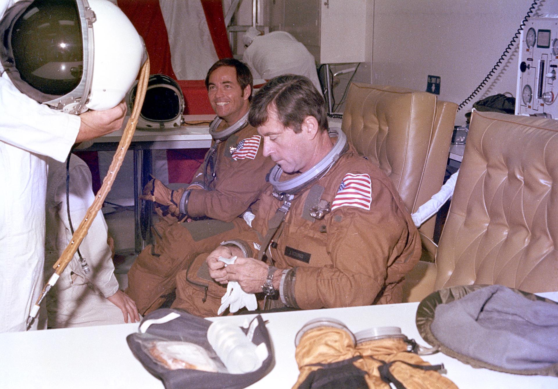 Technicians assist Columbia's prime crew astronauts John Young (right) and Bob Crippen (left) during suit-up operations