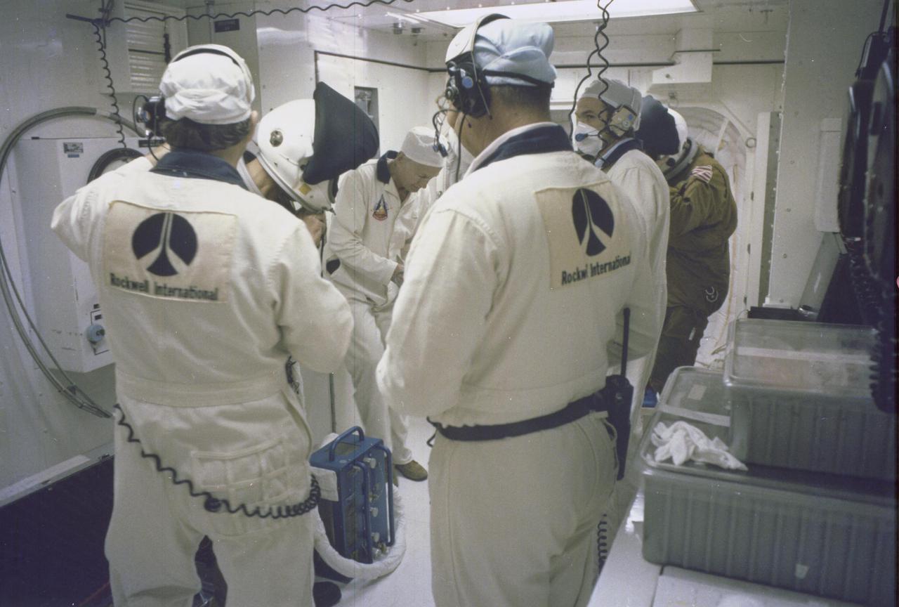 KENNEDY SPACE CENTER, FLA.  -  Astronauts John Young, commander, and Robert Crippen, pilot, are assisted by members of the closeout crew as they enter the cockpit of Columbia for the maiden flight of the Space Shuttle on April 12.  Fully suited, they entered through the clean room at Launch Pad 39A.  Launch followed at a few seconds past 7 a.m., beginning an orbital mission scheduled to last for 54 hours, ending with an unpowered landing at Edwards Air Force Base in California. The STS-1 mission, known as a shuttle systems test flight, will seek to demonstrate safe launch into orbit and safe return of the orbiter and crew and verify the combined performance of the entire shuttle vehicle -- orbiter, solid rocket boosters and external tank.