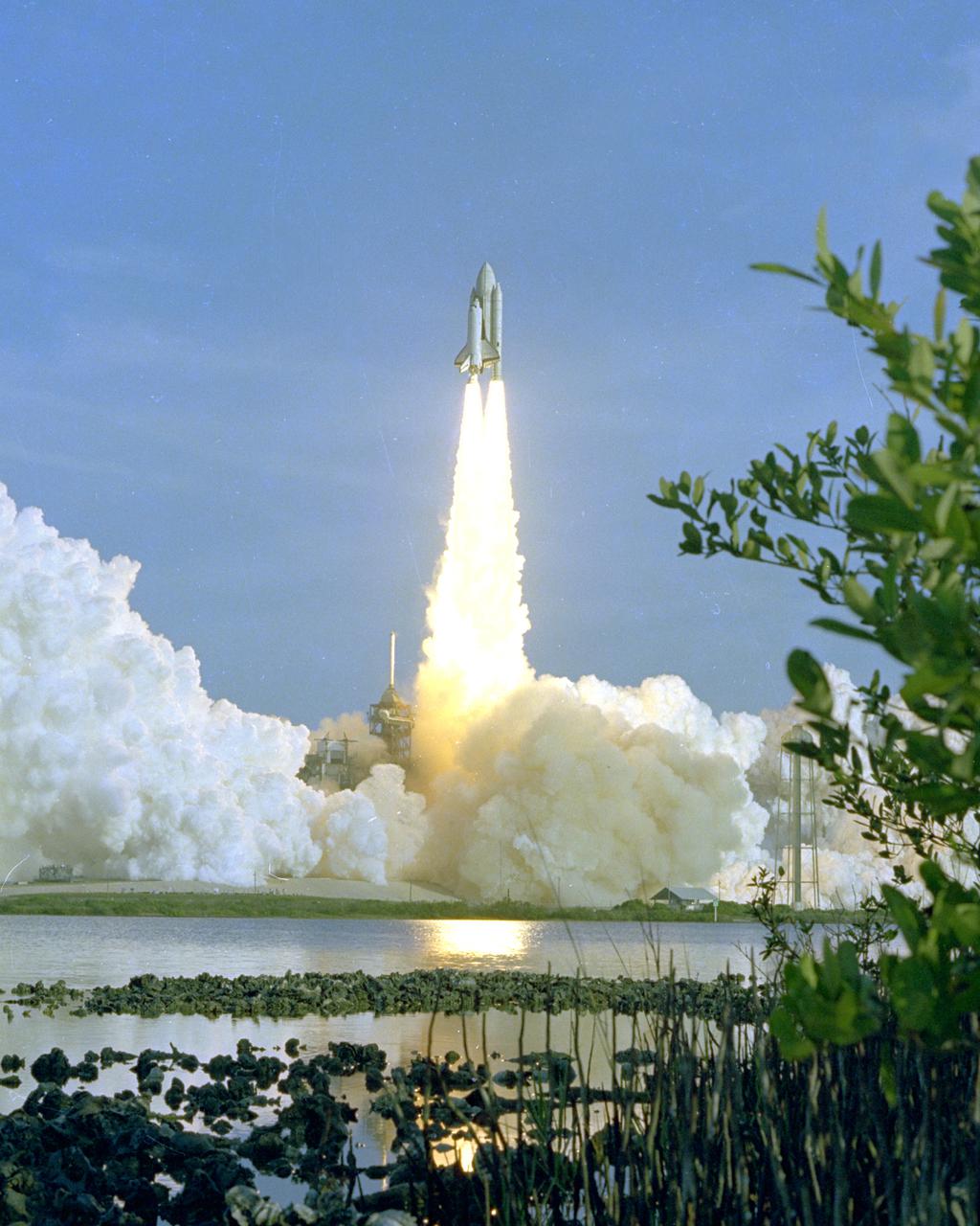 KENNEDY SPACE CENTER, FLA. - The Space Shuttle Columbia rises off Pad 39A a few seconds past 7 a.m. on April 12, 1981 — the dawn of a new age in spaceflight. Onboard, astronauts John Young and Bob Crippen ride toward orbit following a successful liftoff of the first Space Shuttle mission. Mission plans call for the Columbia to remain in orbit for about 54 hours, during which astronauts Young and Criipen will perform a series of checkout activities designed to test the Space Shuttle's systems in space for the first time. The Columbia is scheduled to glide to an airplane-like landing at Edwards Air Force Base, Calif.