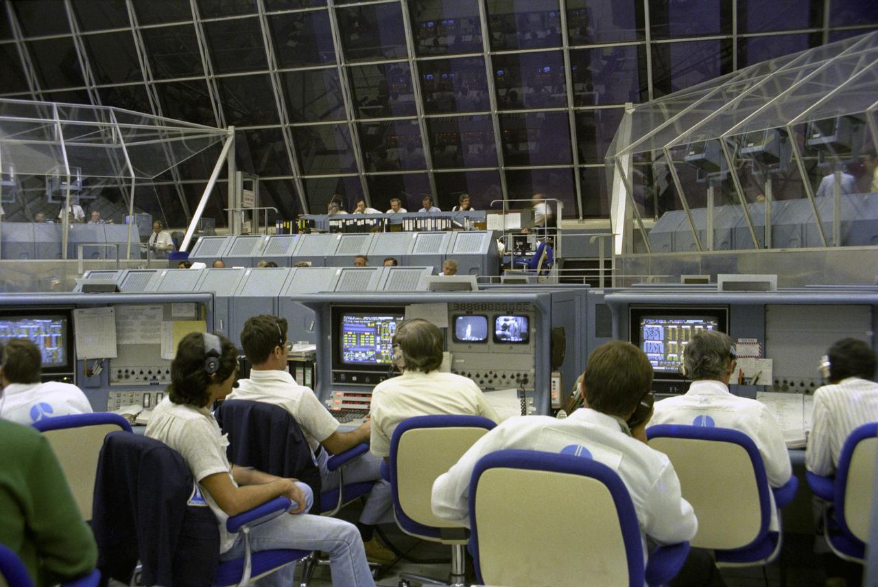 KENNEDY SPACE CENTER, FLA. - Heavy, blast-proof steel louvers seal the large windows of the Launch Control Center’s firing room against mishaps that fail to occur when the first flight of the Space Shuttle is launched from Pad 39A 3.5 mile away. Launch staff, intently watching their computer readouts and TV monitors during the critical moments of launch, will cheer and wave miniature American flags when Astronauts John Young and Robert Crippen complete their fiery rocket ascent safely.
