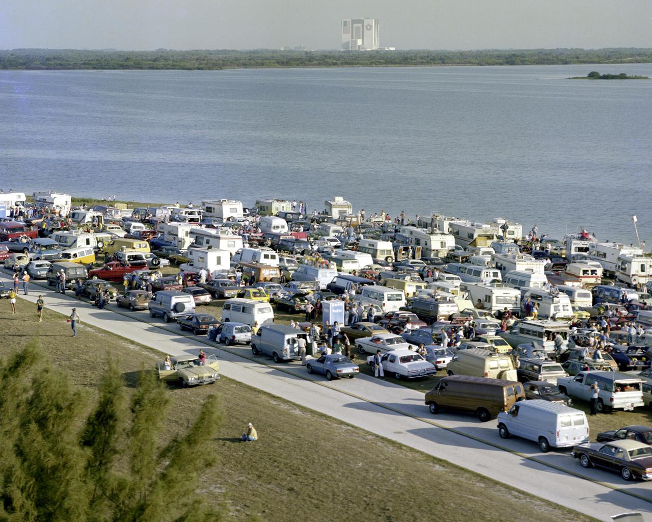 KENNEDY SPACE CENTER, FLA.  -   Thousands of Space Center guests line the NASA Causeway awaiting the first launch of the Space Shuttle.  The Vehicle Assembly Building where the orbiter is mated to the solid rocket boosters and the external tank, is visible in the distance.  The STS-1 mission, known as a shuttle systems test flight, will seek to demonstrate safe launch into orbit and safe return of the orbiter and crew and verify the combined performance of the entire shuttle vehicle -- orbiter, solid rocket boosters and external tank.