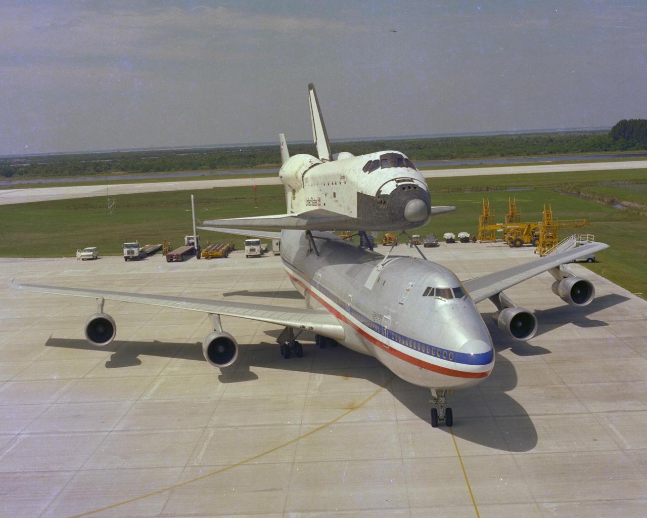 KENNEDY SPACE CENTER, FLA. - The Space Shuttle Orbiter Columbia - riding piggyback atop a modified 747 jet called the Shuttle Carrier Aircraft - arrives at Kennedy Space Center after a two-day journey from the Dryden Flight Research Center in California. Welcomed home by a crowd of KSC employees and their families and guests, Columbia touched down on the Shuttle Landing Facility at 11:23 a.m. Tuesday, two weeks after its return to Earth from the first Space Shuttle flight into space. The orbiter and SCA are seen here parked in front of the Mate_Demate Device, where the orbiter will be hoisted off the 747.