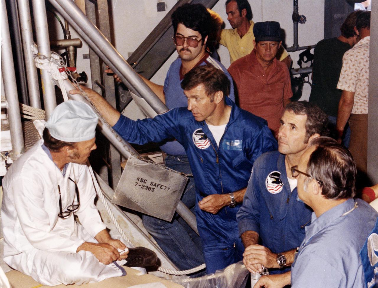 KENNEDY SPACE CENTER, FLA. -- At Pad A, Launch Complex 39, astronauts Joe Engle, left, and Richard Truly talk with technicians and inspect the Space Shuttle vehicle that will propel them into orbit later this fall.