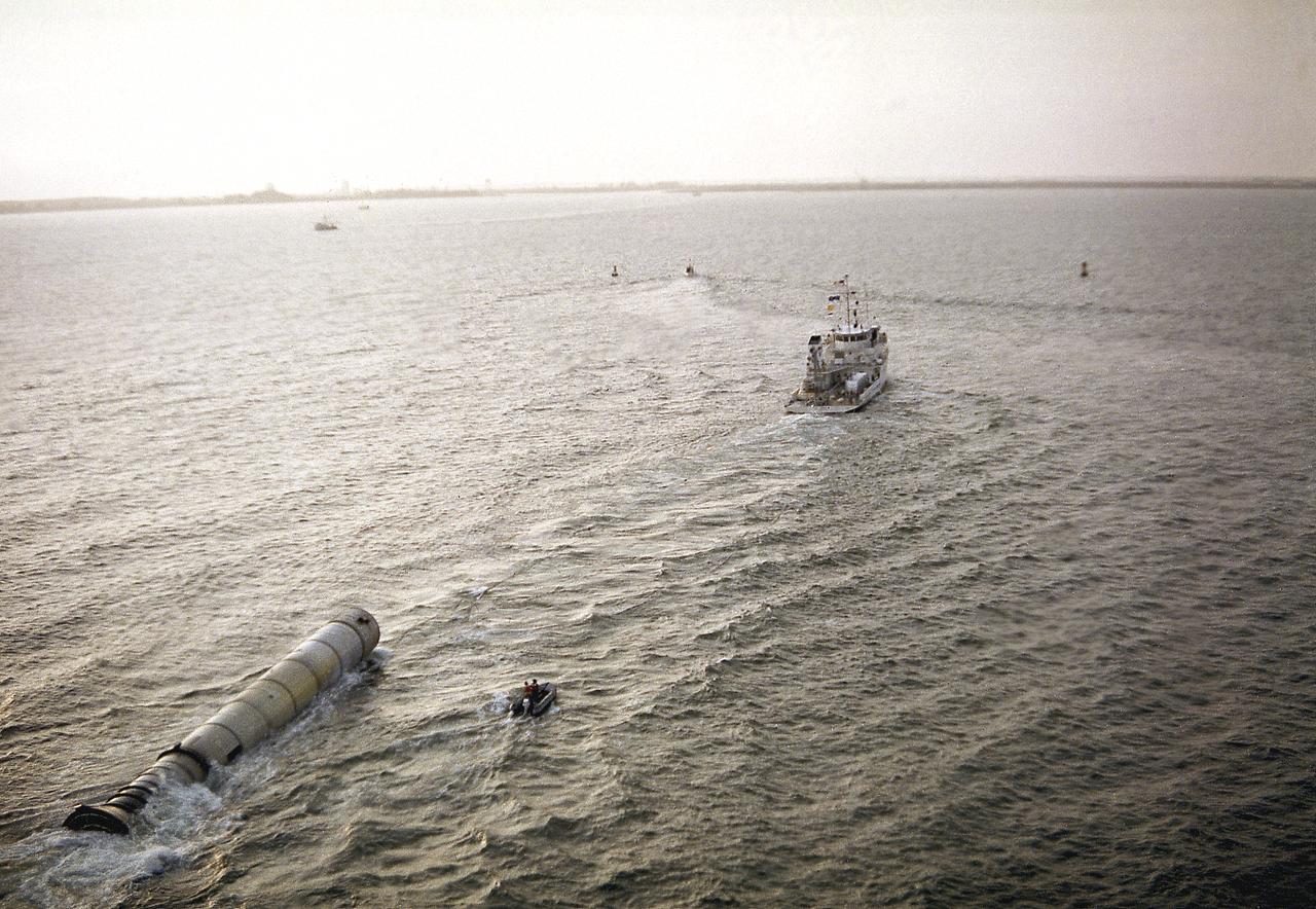 The towing ship, Liberty, towed a recovered solid rocket booster (SRB) for the STS-3 mission to Port Canaveral, Florida. The recovered SRB would be inspected and refurbished for reuse. The Shuttle's SRB's and solid rocket motors (SRM's) are the largest ever built and the first designed for refurbishment and reuse. Standing nearly 150-feet high, the twin boosters provide the majority of thrust for the first two minutes of flight, about 5.8 million pounds. The requirement for reusability dictated durable materials and construction to preclude corrosion of the hardware exposed to the harsh seawater environment. The SRB contains a complete recovery subsystem that includes parachutes, beacons, lights, and tow fixture.