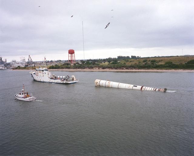 This is a photo of the recovery ship, UTC Liberty, towing the left booster of the STS-5 flight vehicle into Port Canaveral.