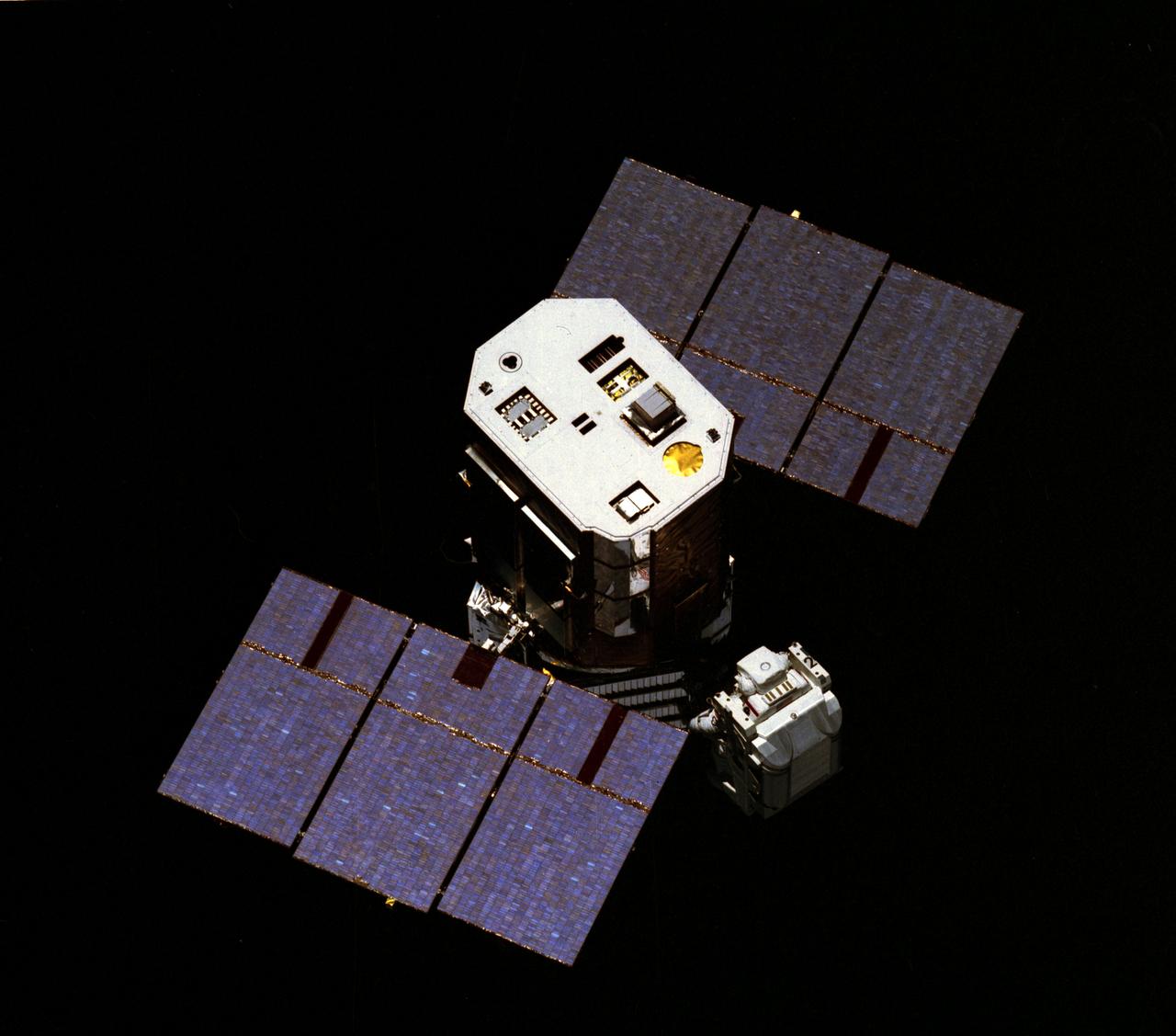 Launched April 6, 1984, one of the goals of the STS-41C mission was to repair the damaged free-flying Solar Maximum Mission Satellite (SMMS), or Solar Max. The original plan was to make an excursion out to the SMMS and capture it for necessary repairs. Pictured is Mission Specialist George Nelson approaching the damaged satellite in a capture attempt. This attempted feat was unsuccessful. It was necessary to capture the satellite via the orbiter's Remote Manipulator System (RMS) and secure it into the cargo bay in order to perform the repairs, which included replacing the altitude control system and the coronograph/polarimeter electronics box. The SMMS was originally launched into space via the Delta Rocket in February 1980, with the purpose to provide a means of studying solar flares during the most active part of the current sunspot cycle. Dr. Einar Tandberg-Hanssen of Marshall Space Flight Center's Space Sciences Lab was principal investigator for the Ultraviolet Spectrometer and Polarimeter, one of the seven experiments of the Solar Max.