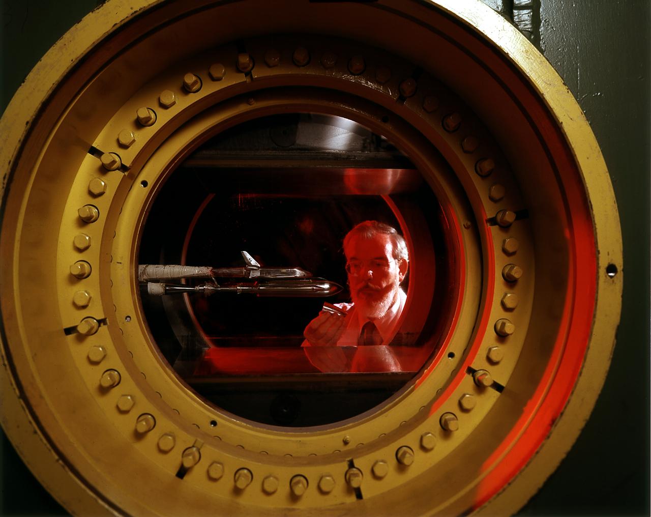 An engineer at the Marshall Space Flight Center (MSFC) observes a model of the Space Shuttle Orbiter being tested in the MSFC's 14x14-Inch Trisonic Wind Tunnel. The 14-Inch Wind Tunnel is a trisonic wind tunnel. This means it is capable of running subsonic, below the speed of sound; transonic, at or near the speed of sound (Mach 1,760 miles per hour at sea level); or supersonic, greater than Mach 1 up to Mach 5. It is an intermittent blowdown tunnel that operates by high pressure air flowing from storage to either vacuum or atmospheric conditions. The MSFC 14x14-Inch Trisonic Wind Tunnel has been an integral part of the development of the United States space program Rocket and launch vehicles from the Jupiter-C in 1958, through the Saturn family up to the current Space Shuttle and beyond have been tested in this Wind Tunnel. MSFC's 14x14-Inch Trisonic Wind Tunnel, as with most other wind tunnels, is named after the size of the test section. The 14-Inch Wind Tunnel, as in the past, will continue to play a large but unseen role in the development of America's space program.