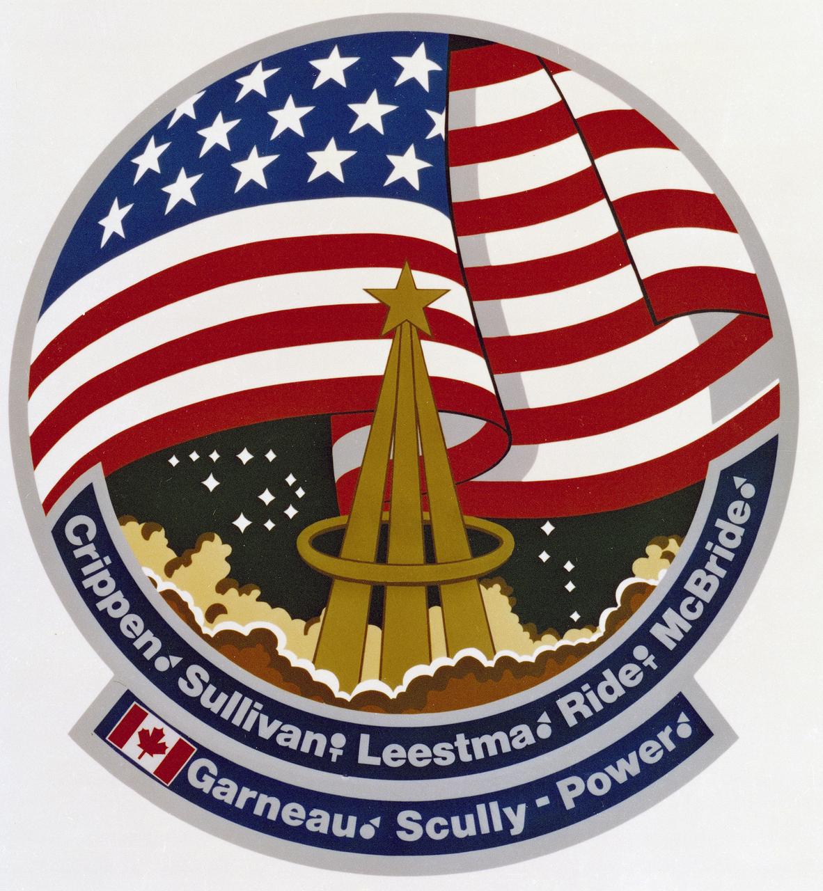 The 41-G mission insignia focuses on its seven crew members (first to exceed six), the U.S. Flag and the Unity symbol known as the astronaut pin. The pin design in center shows a trio of trajectories merging in infinite space, capped by a bright shining star and encircled by an elliptical wreath denoting orbital flight. 