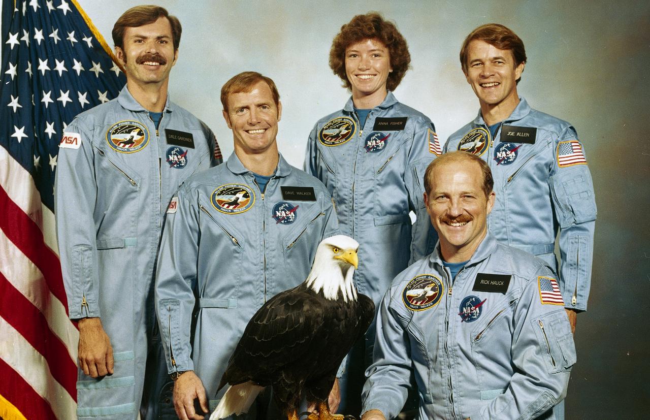 The crew assigned to the STS-51A mission included Frederick H. Hauck, commander,who is seated to the right. Standing, left to right, are Dale A. Gardner, mission specialist; David M. Walker, pilot; and mission specialists Anna L. Fisher, and Joseph P. Allen. Launched aboard the Space Shuttle Discovery on November 8, 1984 at 7:15:00 am (EST), the STS-51A mission deployed the Canadian communications satellite TELLESAT-H (ANIK), and the defense communications satellite SYCOM IV-1 (also known as LEASAT-1). In addition, 2 malfunctioning satellites were retrieved: the PALAPA-B2 and the WESTAR-VI.