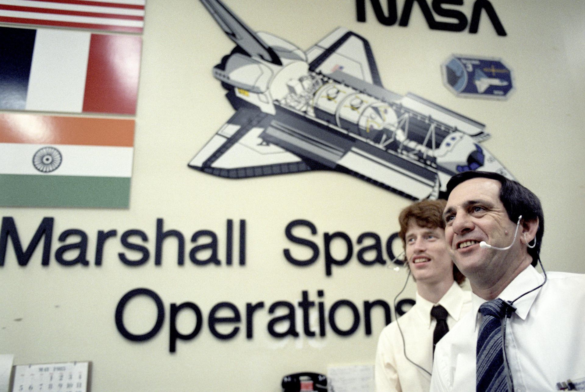 Two men with headsets at the Marshall Space Operations center for the Spacelab 3 mission