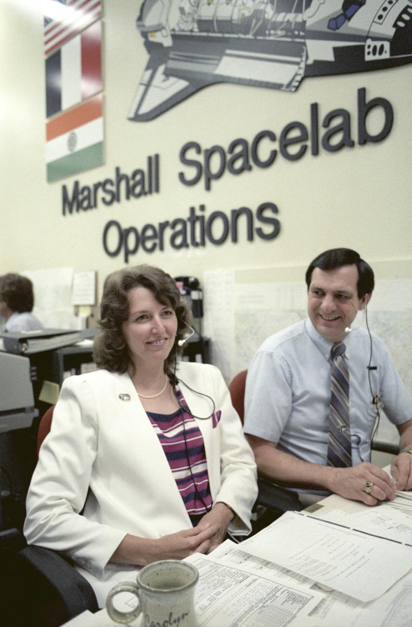 Spacelab-3 launched aboard STS-51B, with the major science objective being to perform engineering tests on two new facilities: the rodent animal holding facility and the primate animal holding facility. In addition, scientists observed the animals to obtain first hand knowledge of the effects of launch and reentry stresses and behavior. The need for suitable animal housing to support research in space led to the development of the Research Animal Holding Facility at the Ames Research Center. Scientists often study animals to find clues to human physiology and behavior. Rats, insects, and microorganisms had already been studied aboard the Shuttle on previous missions. On Spacelab-3, scientists had a chance to observe a large number of animals living in space in a specially designed and independently controlled housing facility. Marshall Space Flight Center (MSFC) had management responsibility for the Spacelab-3 mission. This photograph depicts activities during the mission at the Huntsville Operations Support Center (HOSC) Spacelab Payload Operations Control Center (SL POCC) at MSFC.