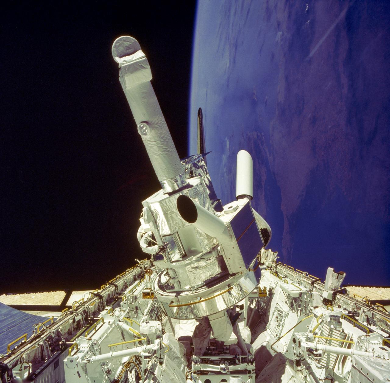 This photograph shows the Instrument Pointing System (IPS) for Spacelab-2 being deployed in the cargo bay of the Space Shuttle Orbiter Challenger. The European Space Agency (ESA) developed this irnovative pointing system for the Spacelab program. Previously, instruments were pointed toward particular celestial objects or areas by maneuvering the Shuttle to an appropriate attitude. The IPS could aim instruments more accurately than the Shuttle and kept them fixed on a target as the Shuttle moved. On the first pallet, three solar instruments and one atmospheric instrument were mounted on the IPS. Spacelab-2 was the first pallet-only mission. One of the goals of the mission was to verify that the pallets' configuration was satisfactory for observations and research. Except for two biological experiments and an experiment that used ground-based instruments, the Spacelab-2 scientific instruments needed direct exposure to space. The Spacelab-2 mission was designed to capitalize on the Shuttle-Spacelab capabilities to carry very large instruments, launch and retrieve satellites, and point several instruments independently with accuracy and stability. Spacelab-2 (STS-51F, 19th Shuttle mission) was launched on July 29, 1985 aboard the Space Shuttle Orbiter Challenger. The Marshall Space Flight Center had overall management responsibilities of the Spacelab missions.