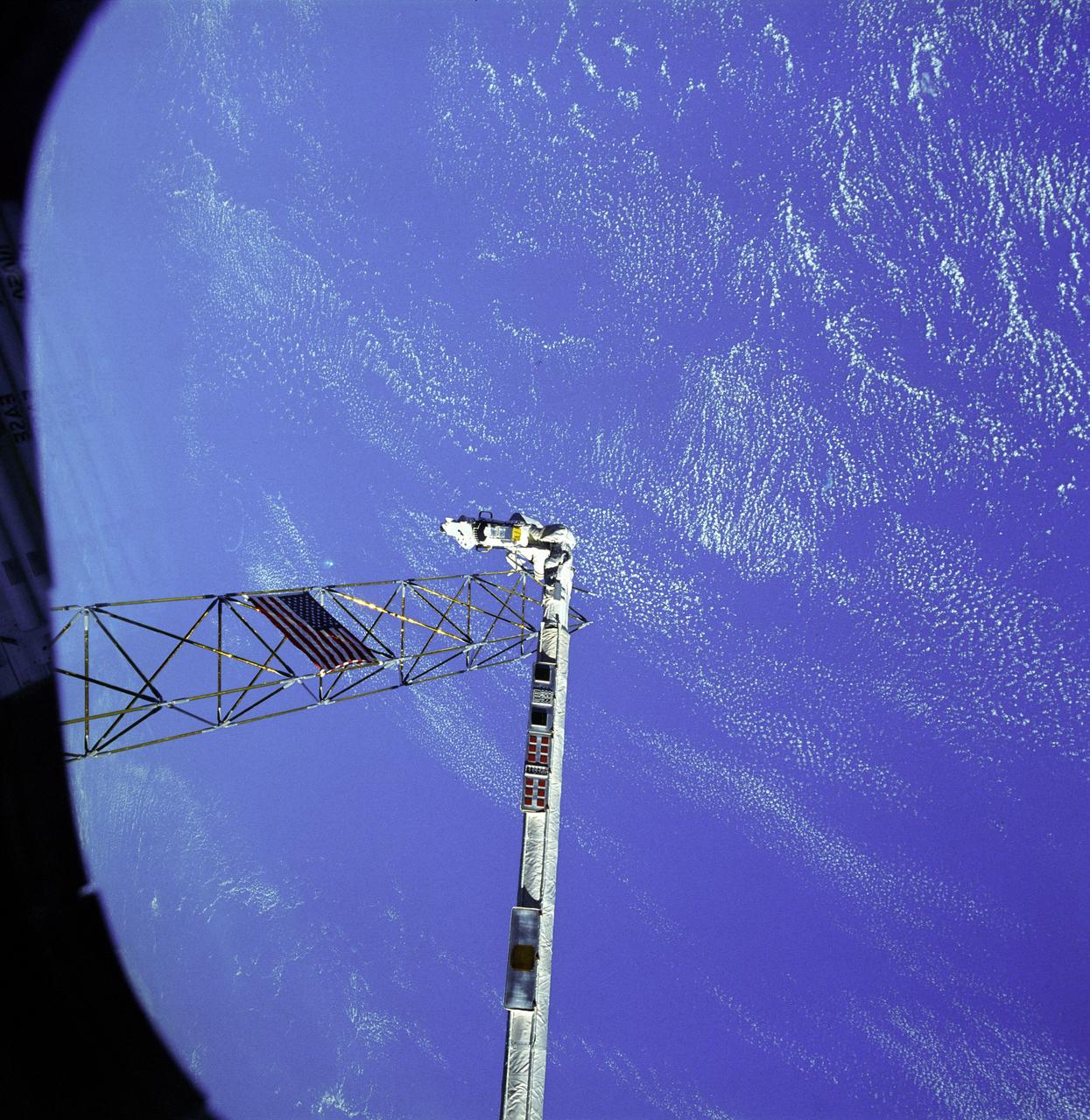 The crew assigned to the STS-61B mission included Bryan D. O’Conner, pilot; Brewster H. Shaw, commander; Charles D. Walker, payload specialist; mission specialists Jerry L. Ross, Mary L. Cleave, and Sherwood C. Spring; and Rodolpho Neri Vela, payload specialist. Launched aboard the Space Shuttle Atlantis November 28, 1985 at 7:29:00 pm (EST), the STS-61B mission’s primary payload included three communications satellites: MORELOS-B (Mexico); AUSSAT-2 (Australia); and SATCOM KU-2 (RCA Americom). Two experiments were conducted to test assembling erectable structures in space: EASE (Experimental Assembly of Structures in Extravehicular Activity), and ACCESS (Assembly Concept for Construction of Erectable Space Structure). In a joint venture between NASA/Langley Research Center in Hampton, Virginia, and the Marshall Space Flight Center (MSFC), EASE and ACCESS were developed and demonstrated at MSFC's Neutral Buoyancy Simulator (NBS). In this STS-61B onboard photo, astronaut Ross works on ACCESS high above the orbiter. The primary objective of these experiments was to test the structural assembly concepts for suitability as the framework for larger space structures and to identify ways to improve the productivity of space construction.
