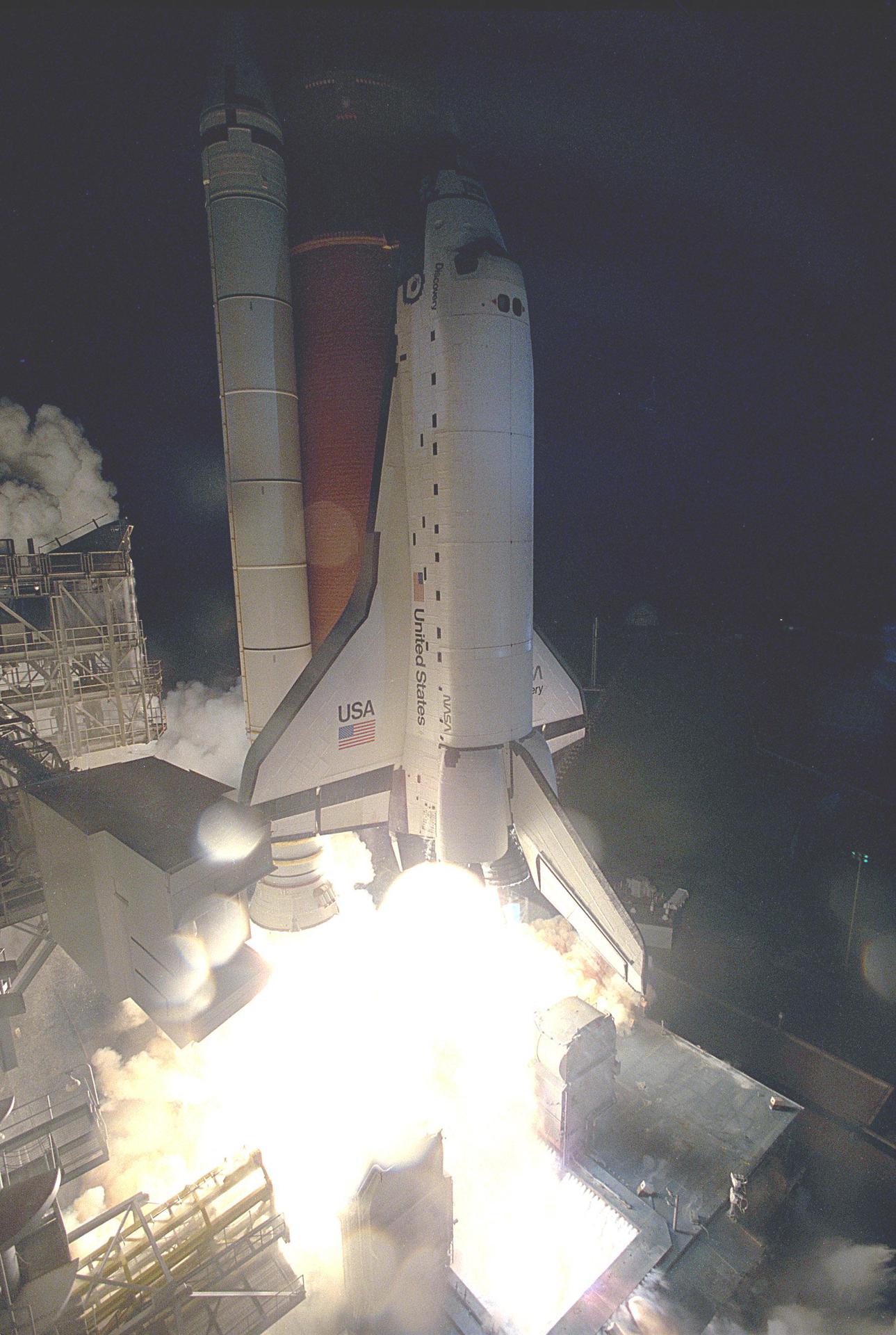 Space shuttle Discovery lifts off from the launch pad at Kennedy Space Center