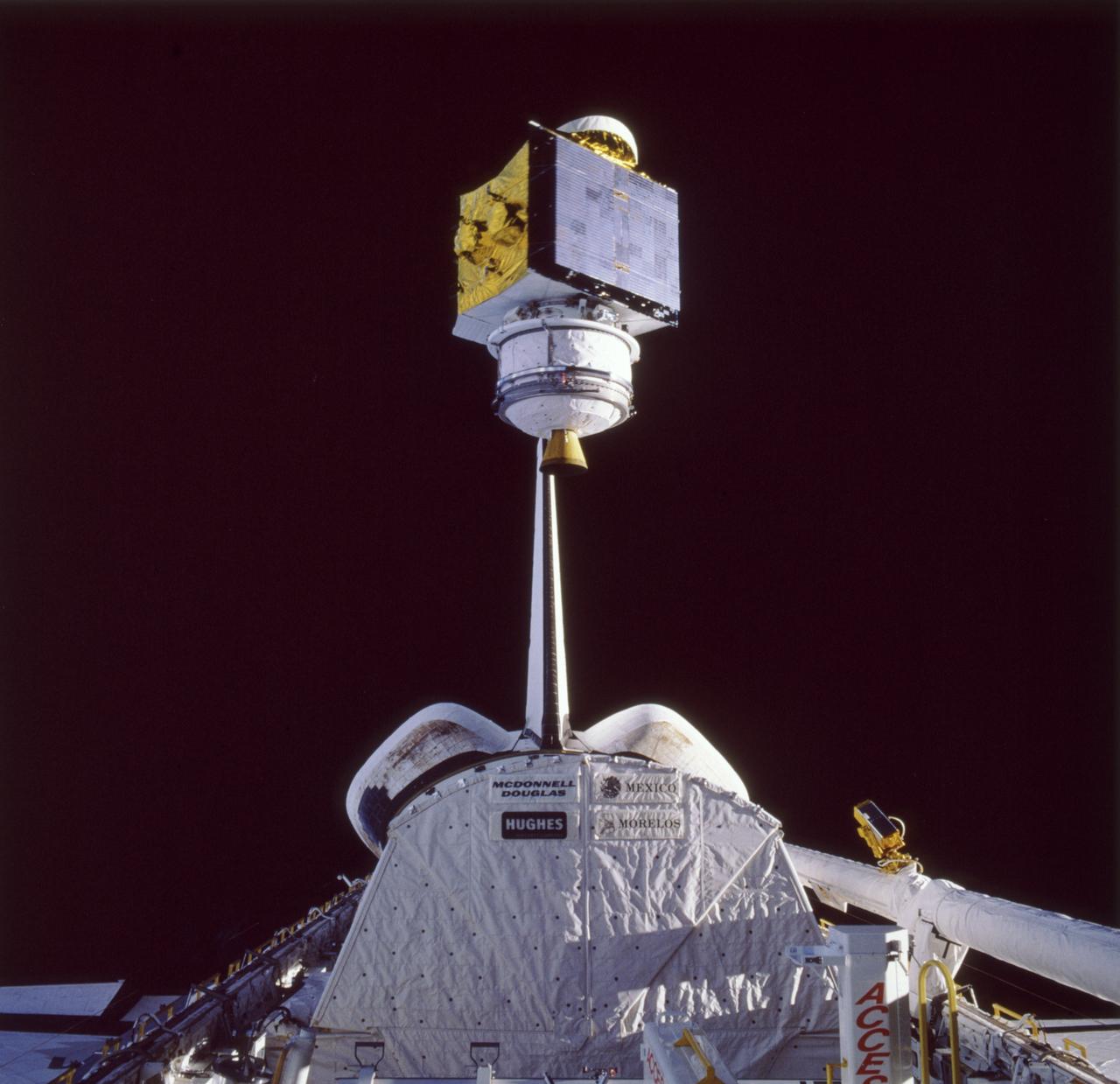 In this photograph the SATCOM KU-2 satellite attached to a Payload Assist Module-D (PAM-D) is being released from the cargo bay of the Space Shuttle Orbiter Atlantis during STS-61B, the 23rd Shuttle Mission. The PAM-D is an upper stage system used to deploy payloads to a required orbit unattainable by the spacecraft. SATCOM KU-2 is an RCA communication satellite and was launched on November 26, 1985.