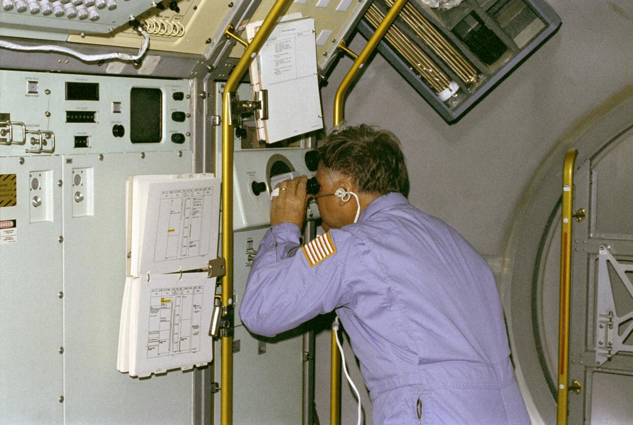 The primary purpose of the Spacelab-3 mission was to conduct materials science experiments in a stable low-gravity environment. In addition, the crew performed research in life sciences, fluid mechanics, atmospheric science, and astronomy. Spacelab-3 was equipped with several new minilabs, special facilities that would be used repeatedly on future flights. Two elaborate crystal growth furnaces, a life support and housing facility for small animals, and two types of apparatus for the study of fluids were evaluated on their inaugural flight. In this photograph, astronaut Don Lind observes the mercuric iodide growth experiment through a microscope at the vapor crystal growth furnace. The goals of this investigation were to grow near-perfect single crystals of mercuric iodide and to gain improved understanding of crystal growth by a vapor process. Mercuric iodide crystals have practical use as sensitive x-ray and gamma-ray detectors, and in portable detector devices for nuclear power plant monitoring, natural resource prospecting, biomedical applications in diagnosis and therapy, and in astronomical instruments. Managed by the Marshall Space Flight Center, Spacelab-3 (STS-51B) was launched aboard the Space Shuttle Orbiter Challenger on April 29, 1985.