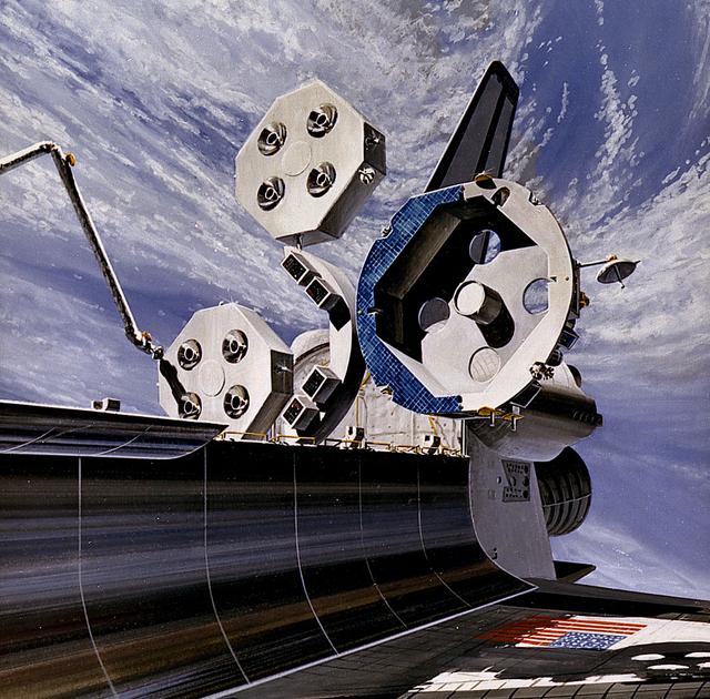 In this 1986 artist's concept, the Orbital Maneuvering Vehicle (OMV), undergoes changeout of the Propulsion Module outside the Space Shuttle Cargo Bay. As envisioned by Marshall Space Flight Center plarners, the OMV would be a remotely-controlled free-flying space tug which would place, rendezvous, dock, and retrieve orbital payloads.