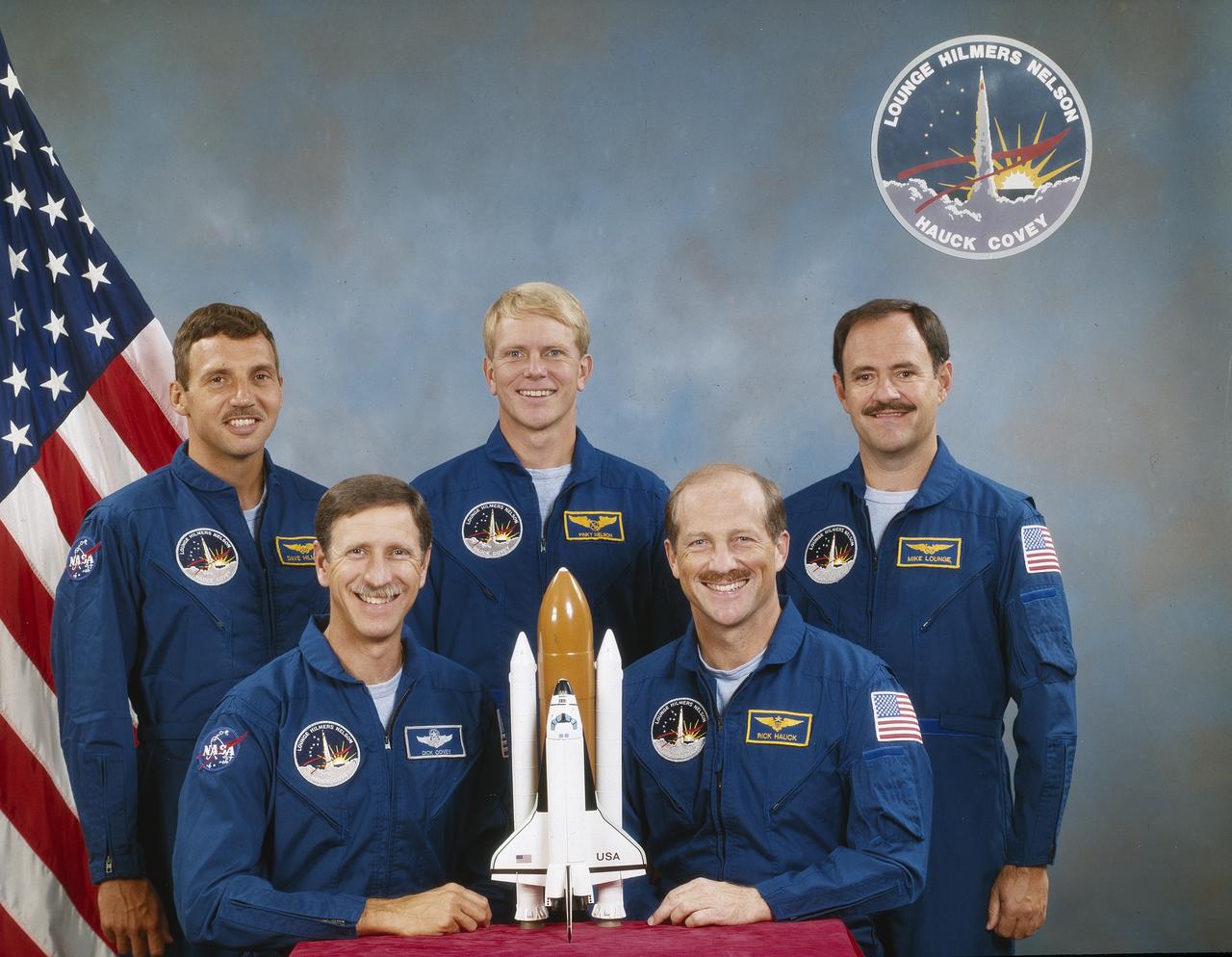 Five astronauts composed the crew of the STS-26 mission. Pictured in the portrait (left to right) are David C. Hilmer, mission specialist; Richard O. Covey, pilot; George D. Nelson, mission specialist; Frederick H. Hauck, Jr., commander; and John, M. Lounge, mission specialist. Launched aboard the Space Shuttle Orbiter Discovery, liftoff occurred on September 29, 1988 at 11:37am (EDT). This was the 7th flight of the Orbiter Discovery, and the return to flight after the STS-51L mission accident. The primary payload was the NASA Tracking and Data Relay Satellite-3 (TDRS-3).