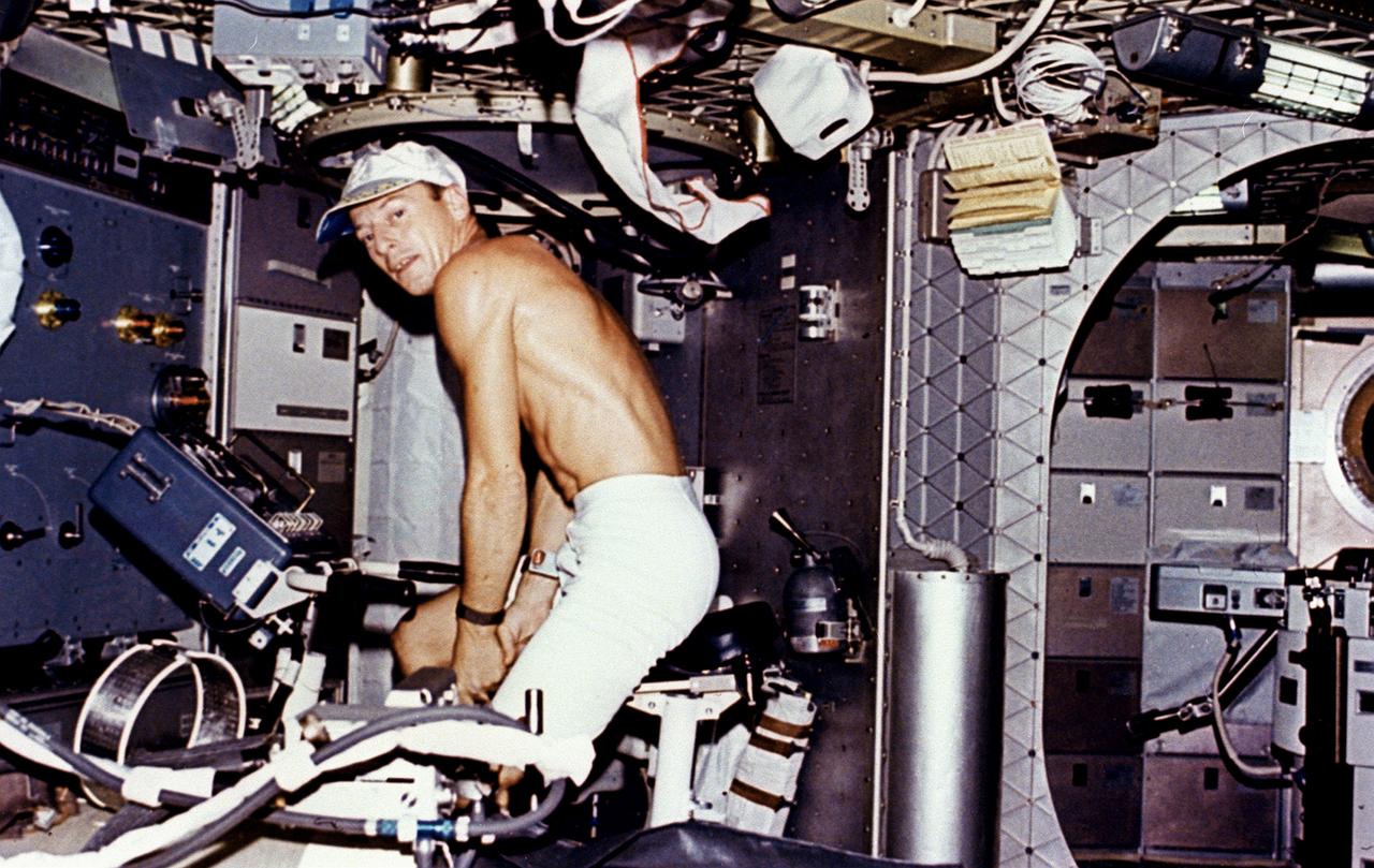 This Skylab-2 onboard photograph shows astronaut Charles "Pete" Conrad exercising on a stationary bicycle (ergometer) used for monitoring the metabolism of the astronauts. The ergometer was used to conduct both Vectorcardiogram experiment (M093) and Metabolic Activity experiment (M171). Experiment M093 was a medical evaluation designed to monitor changes in astronauts' cardiovascular systems, while Experiment M171 was to measure astronauts' metabolic changes during long-duration space missions. 