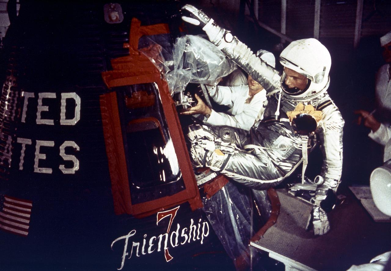 Astronaut John Glenn enters the Mercury spacecraft, Friendship 7, prior to the launch of MA-6 on February 20, 1961 and became the first American who orbited the Earth. The MA-6 mission was the first manned orbital flight boosted by the Mercury-Atlas vehicle, a modified Atlas ICBM (Intercontinental Ballistic Missile), lasted for five hours, and orbited the Earth three times. 