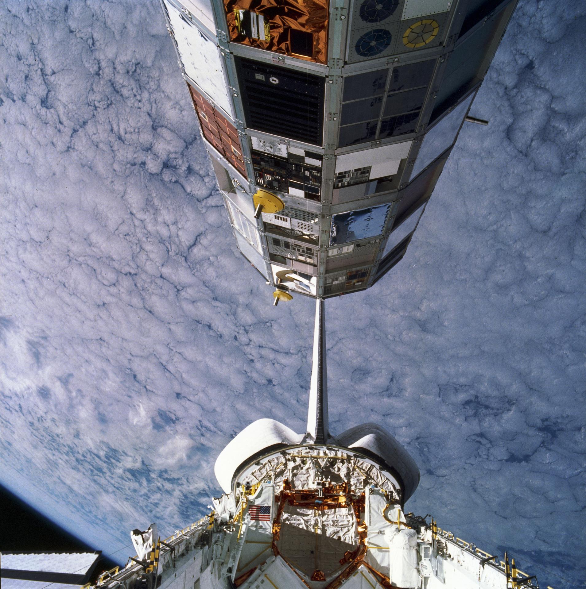 The Long Duration Exposure Facility (LDEF) is deployed from the cargo bay of the Space Shuttle Orbiter