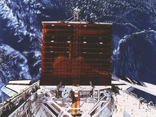 An STS-41D onboard photo shows the Solar Array Experiment (SAE) panel deployment for the Office of Aeronautics and space Technology-1 (OAST-1). OAST-1 is several advanced space technology experiments utilizing a common data system and is mounted on a platform in the Shuttle cargo bay.