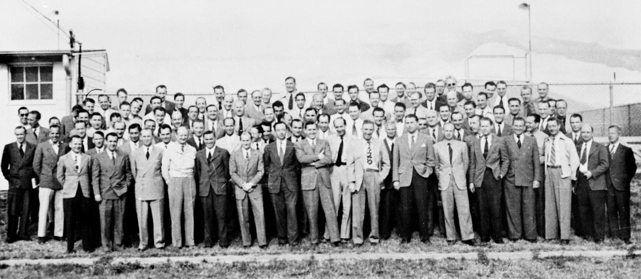 The German Rocket Team, also known as the Von Braun Rocket Team, poses for a group photograph at Fort Bliss, Texas. After World War II ended in 1945, Dr. Wernher von Braun led some 120 of his Peenemuende Colleagues, who developed the V-2 rocket for the German military during the War, to the United Sttes under a contract to the U.S. Army Corps as part of Operation Paperclip. During the following five years the team worked on high altitude firings of the captured V-2 rockets at the White Sands Missile Range in New Mexico, and a guided missile development unit at Fort Bliss, Texas. In April 1950, the group was transferred to the Army Ballistic Missile Agency (ABMA) at Redstone Arsenal in Huntsville, Alabama, and continued to work on the development of the guided missiles for the U.S. Army until transferring to a newly established field center of the National Aeronautic and Space Administration (NASA), George C. Marshall Space Flight Center (MSFC).