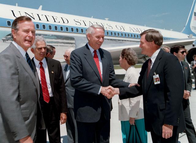 President George Bush and Alabama Governor Guy Hunt are greeted by Marshall's sixth Center Director Thomas J. Lee (1989-1994) upon their arrival at Redstone Arsenal (RSA) airfield. This was the first sitting president to visit Marshall Space Flight Center (MSFC) since President Kennedy's visit almost 30 years ago.
