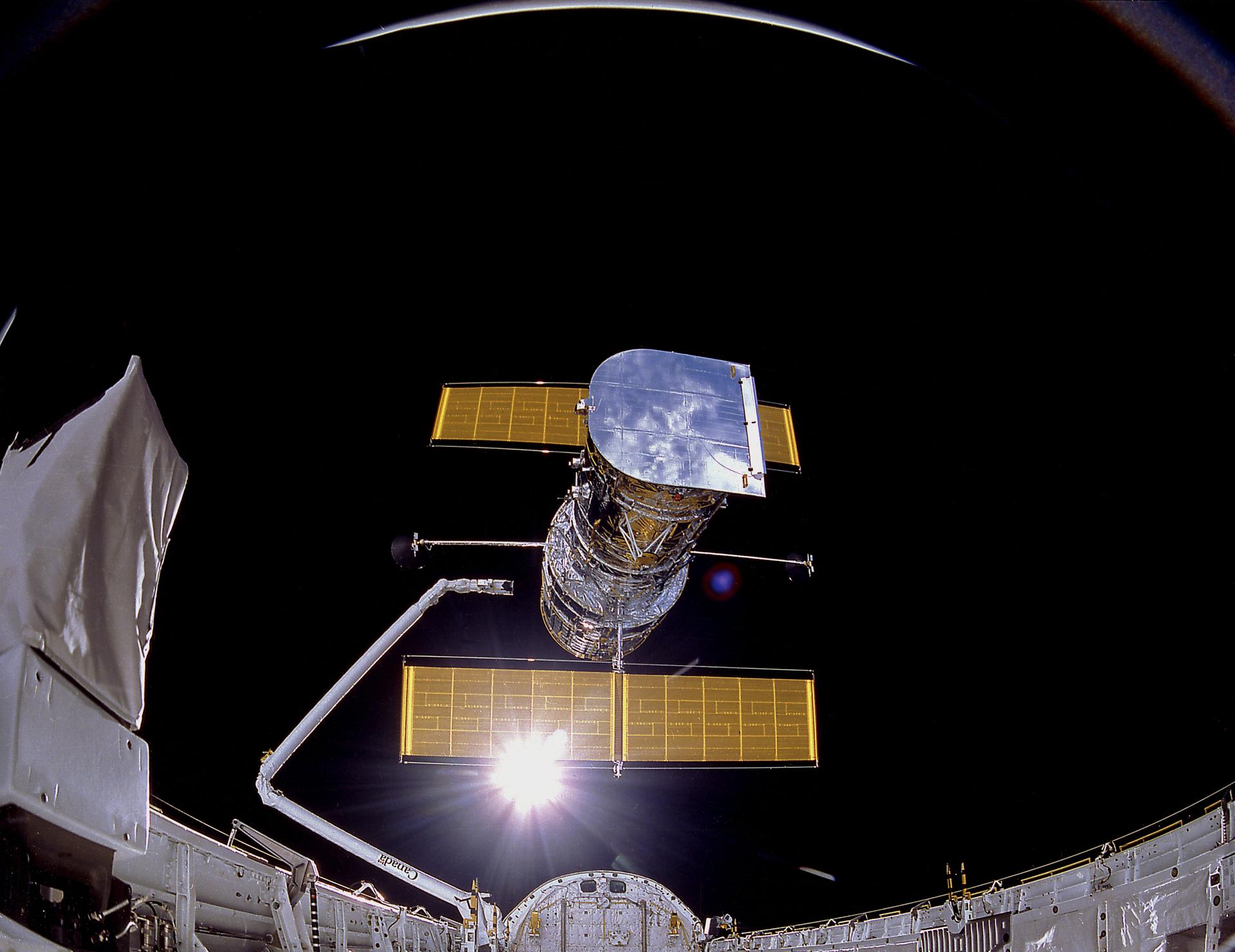 View of the Hubble Space Telescope being prepared for deployment from the Discovery orbiter (STS-31)