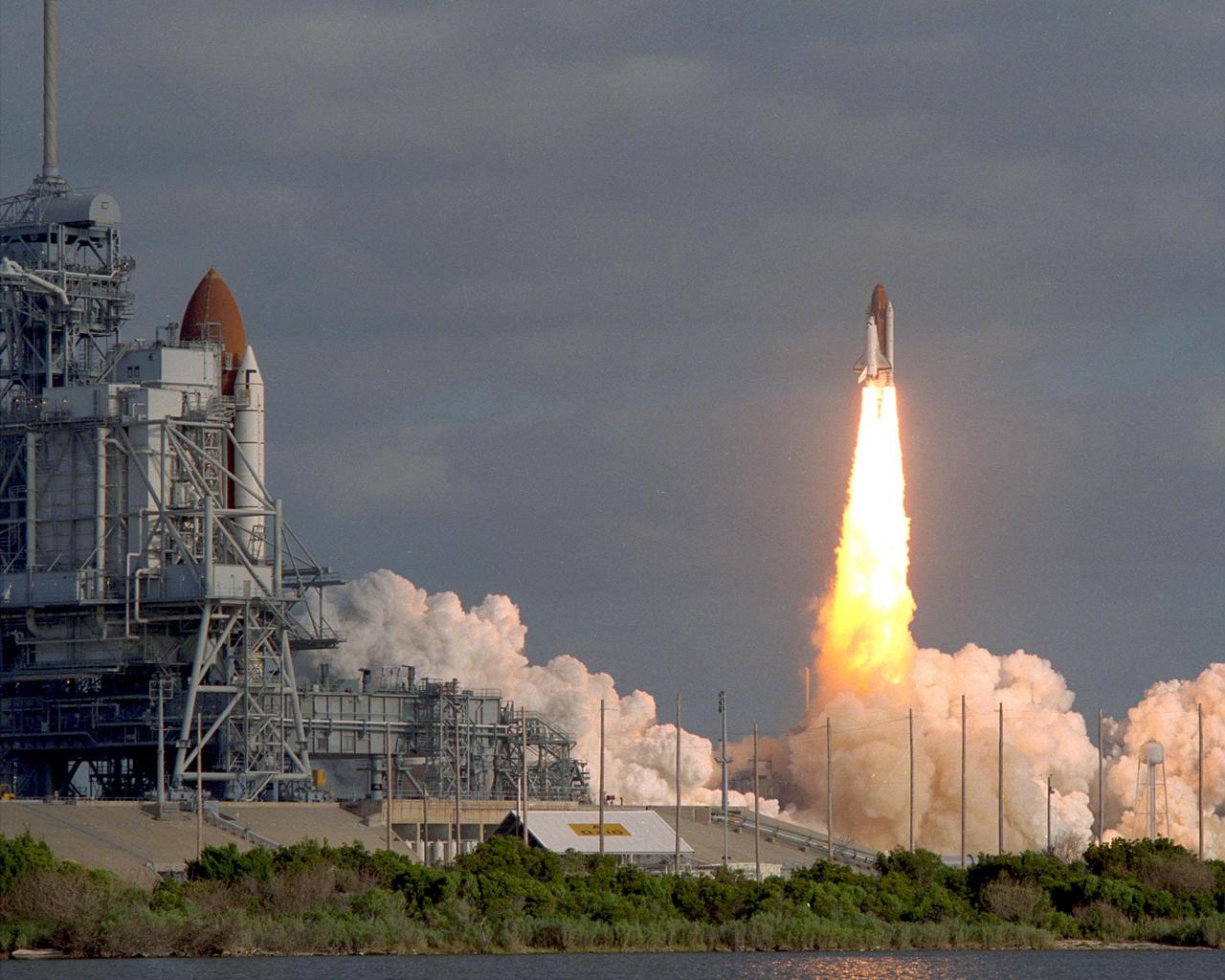 KENNEDY SPACE CENTER, FLA. --  The Space Shuttle Columbia on Pad 39A 'watches' the picture-perfect ascent of sister ship Discovery after liftoff of STS-31.  This was the first time since January 1986 that there was a Shuttle on each pad, which are separated by 1.6 miles.  Discovery, carrying a five-member crew and the Hubble SpaceTelescope, lifted off at 8:34 EDT, April 24.  Columbia, with its Astro-1 observatory, is scheduled for launch in May.