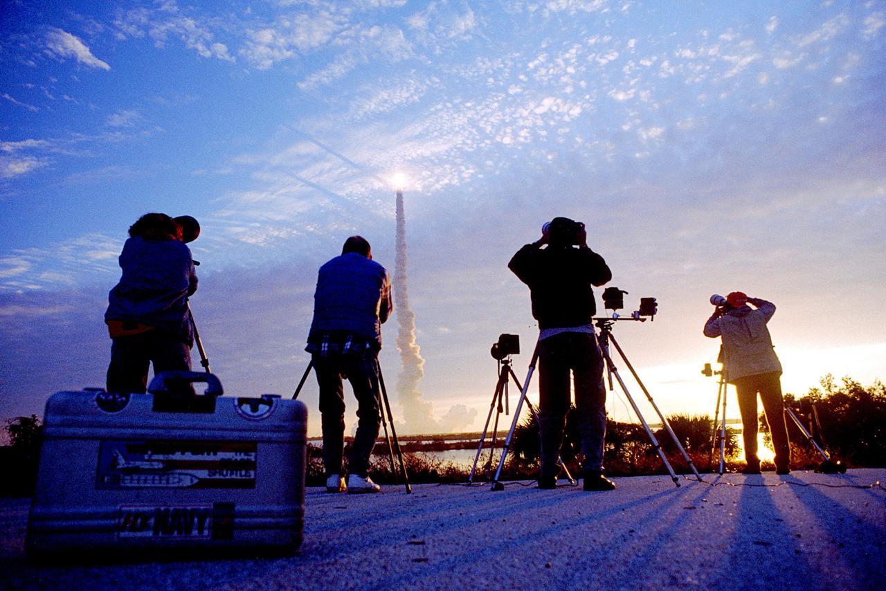 KENNEDY SPACE CENTER, FLA. -- The morning launch of the Shuttle Columbia creates an unforgettable palette of colors, framed by the dark profiles of press photographers standing west of Launch Pad 39B. Columbia's dramatic liftoff on Space Shuttle mission STS-32 occurred at 7:35 a.m. EST, Jan. 9