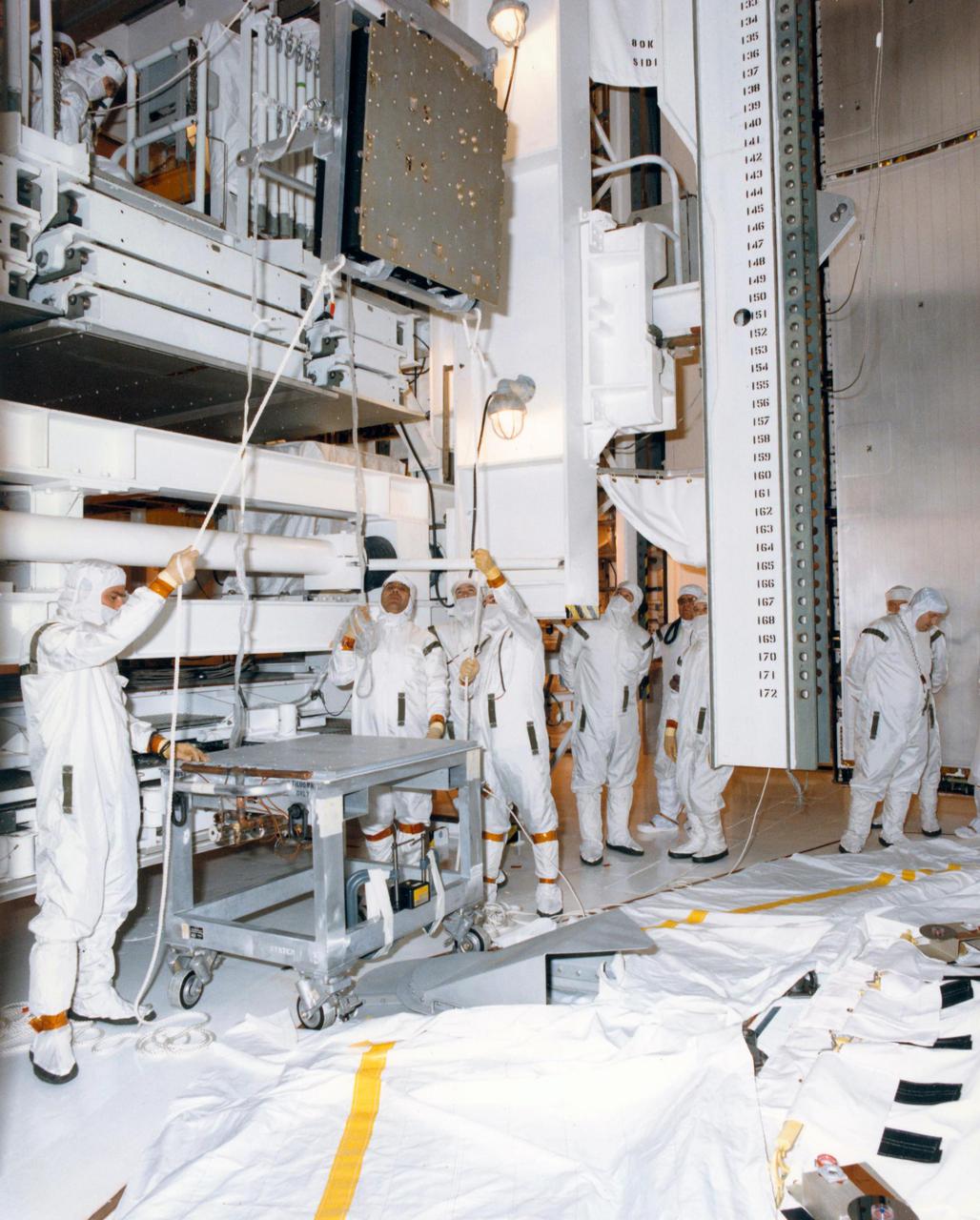 KENNEDY SPACE CENTER, FLA. -- Technicians in the Payload Changeout Room at Launch Pad 39B are removing the batteries from the Hubble Space Telescope for recharging. The two sets of six batteries apiece will be taken to the battery lab inside the Vehicle Assembly Building for 130 hours of recharging, and then reinstalled in the telescope. The recharging became necessary when the first launch attempt of Space Shuttle Mission STS-31 was scrubbed April 10. A second try is set for April 24 at 8:31 a.m. EDT.