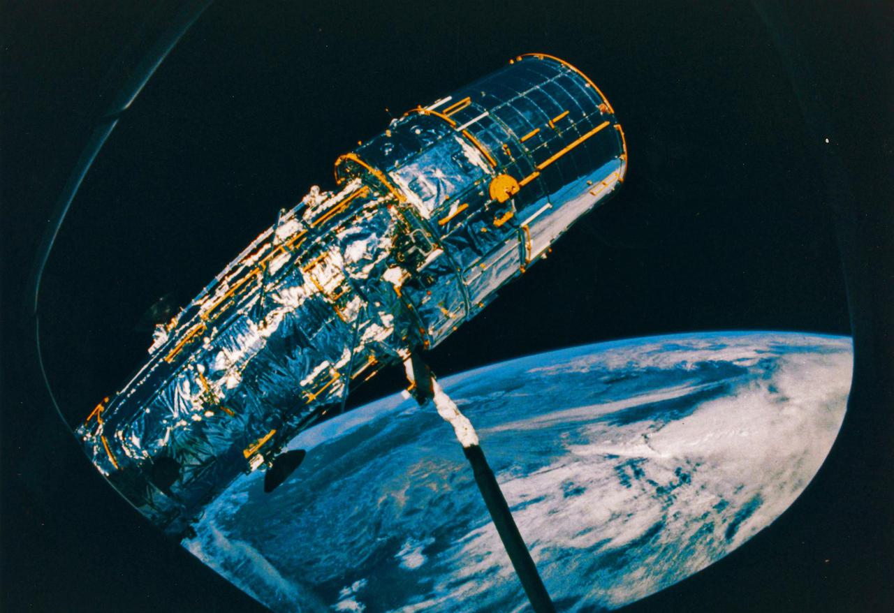 JOHNSON SPACE CENTER, HOUSTON, TEXAS-- View of the Hubble Space Telescope on Discovery's remote manipulator system arm prior to deployment of Hubble's antennae and solar array panels.