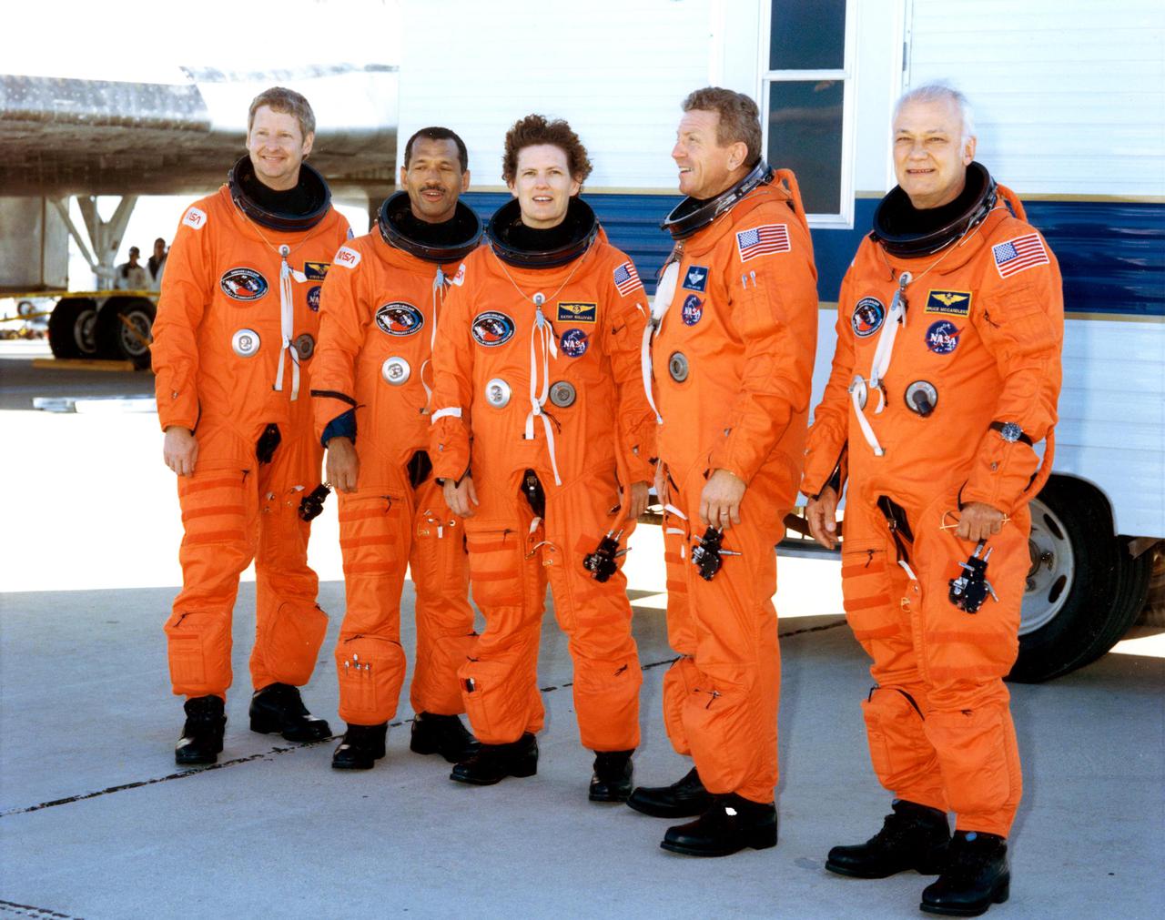DRYDEN FLIGHT RESEARCH FACILITY, EDWARDS, CALIF. -- STS-31 POST-LANDING CREW PORTRAIT -- The astronauts of STS-31 pose for a quick photo near the Space Shuttle Discovery following a smooth landing on the runway at Edwards Air Force Base to complete a highly successful five day mission.  Picture, left to right, are Astronauts Steven A. Hawley, Charles F. Bolden Jr., Kathryn D. Sullivan, Loren J. Shriver, and Bruce McCandless II.  Theirs was an Earth-orbital flight during which the Hubble Space Telescope was sent toward its 15-year mission.  Landing was completed at 6:51 a.m. (PDT), April 29, 1990.