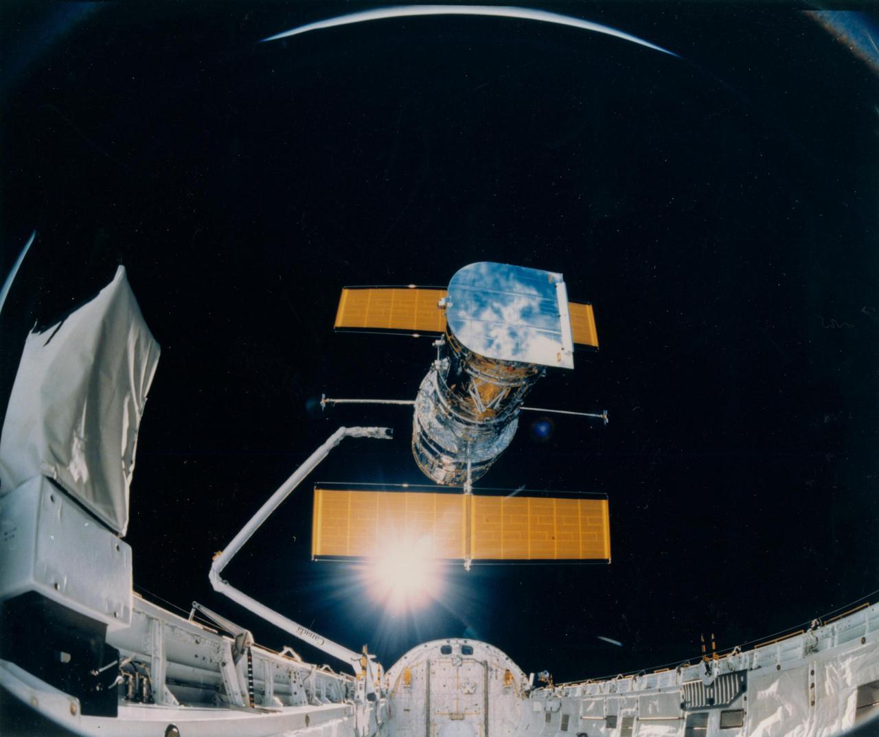 JOHNSON SPACE CENTER, HOUSTON, TEXAS -- STS-31 ONBOARD SCENE -- This photograph was taken by the STS-31 crew aboard the Space Shuttle Discovery and shows the Hubble Space Telescope being deployed on April 25, 1990, from the payload bay. The giant spacecraft is being put in orbit to gather information about a large variety of astronomical objects, from neighboring planets and stars to the most distant galaxies and quasars. The photo was taken by the IMAX Cargo Bay Camera (ICBC), mounted in a container on the port side of Discovery in Bay 12. The camera was remotely controlled by the crew members in the cabin, using a Gas Autonomous Payload Controller (GAPC). The 70mm motion picture coverage of the telescope and its deployment exercises will be featured in an IMAX_Omnimax film for the International Space Year 1992.