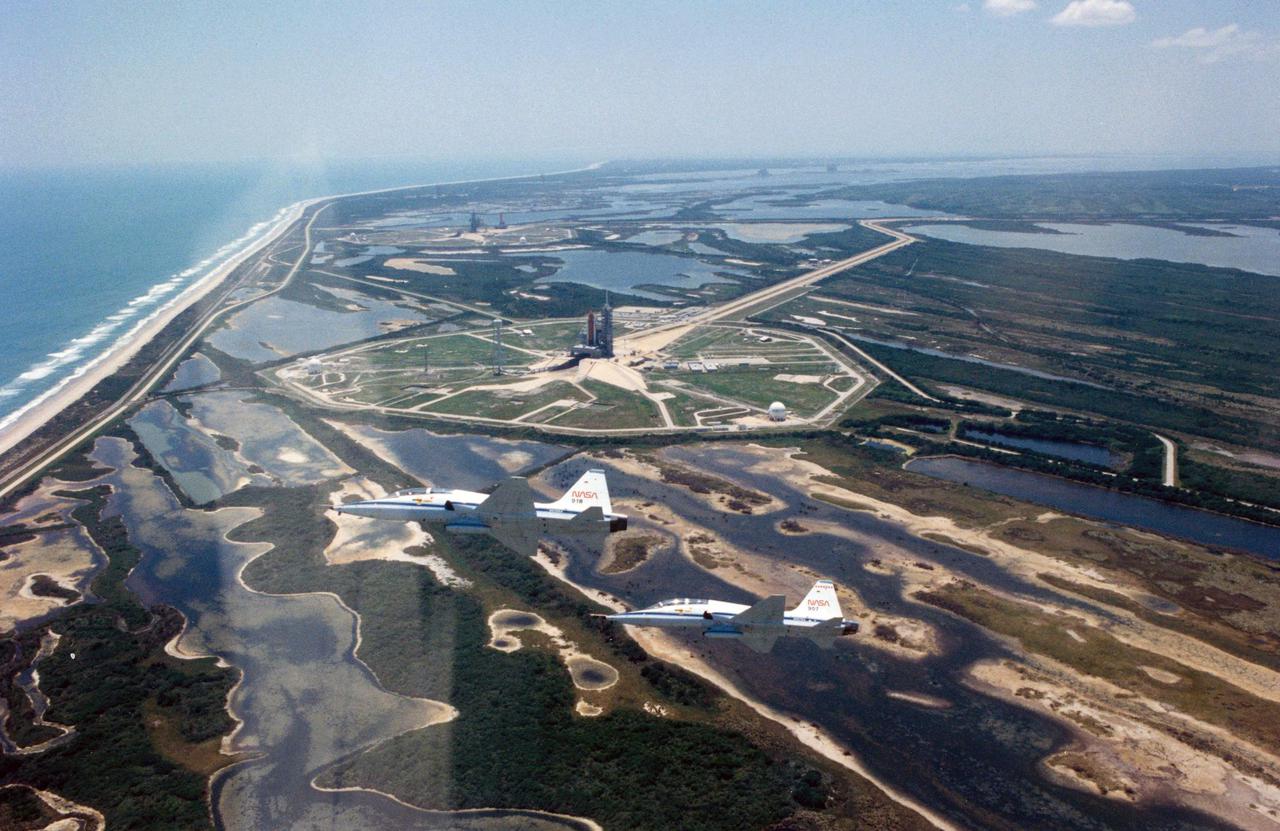 KENNEDY SPACE CENTER, FLA. -- Mission Specialist Kathryn D. Sullivan's camera skills show that the view of Launch Pads 39A and 39B from a T-30 trainer is unforgettable.  Sullivan took the pictures as she and fellow Space Shuttle Mission STS-31 crew members flew into KSC on April 22.  In the foreground, the Shuttle Discovery is poised on Pad B, and in the distance, Columbia rolls out to Pad A.  While Sullivan flew with STS-31 Pilot Charles F. Bolden Jr., Mission Commander Loren J. Shriver and Mission Specialist Steven A. Hawley flew alongside in T-38 #918, and Mission Specialist Bruce McCandless II and NASA Pilot Mario Runco flew in T-38 #907.  STS-31 is set to lift off from Pad B at 8:31 a.m. EDT, April 24.