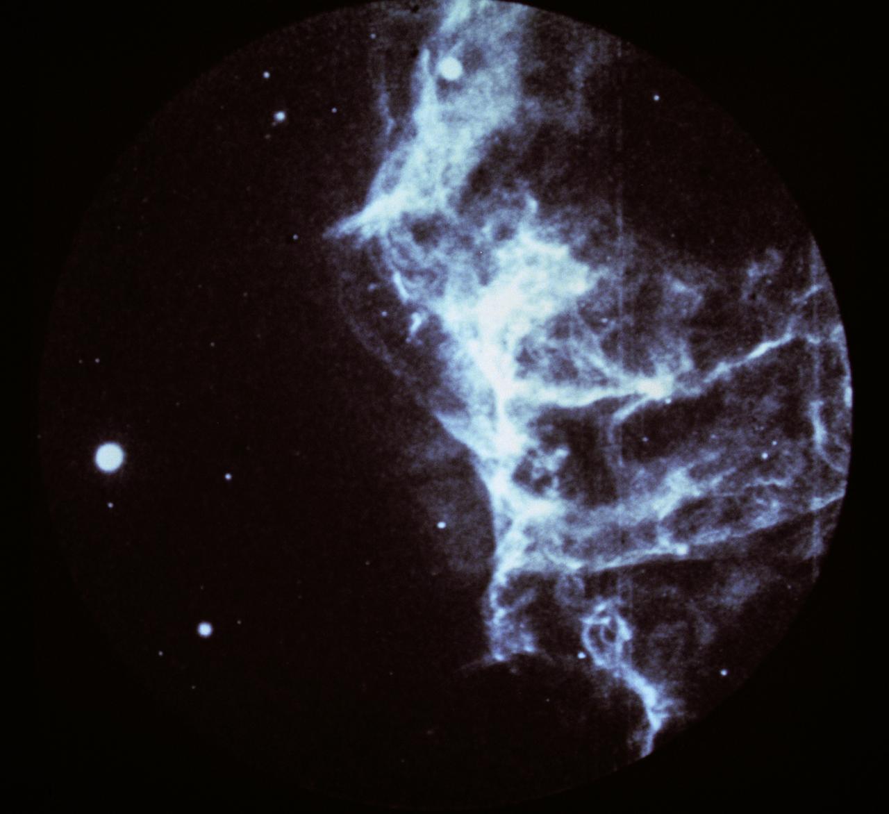 This image shows a part of the Cygnus loop supernova remnant, taken by the Ultraviolet Imaging Telescope (UIT) on the Astro Observatory during the Astro-1 mission (STS-35) on December 5, 1990. Pictured is a portion of the huge Cygnus loop, an array of interstellar gas clouds that have been blasted by a 900,000 mile per hour shock wave from a prehistoric stellar explosion, which occurred about 20,000 years ago, known as supernova. With ultraviolet and x-rays, astronomers can see emissions from extremely hot gases, intense magnetic fields, and other high-energy phenomena that more faintly appear in visible and infrared light or in radio waves that are crucial to deepening the understanding of the universe. The Astro Observatory was designed to explore the universe by observing and measuring the ultraviolet radiation from celestial objects. Three instruments make up the Astro Observatory: The Hopkins Ultraviolet Telescope (HUT), the Ultraviolet Imaging Telescope (UIT), and the Wisconsin Ultraviolet Photo-Polarimetry Experiment (WUPPE). The Marshall Space Flight Center had managment responsibilities for the Astro-1 mission. The Astro-1 Observatory was launched aboard the Space Shuttle Orbiter Columbia (STS-35) on December 2, 1990.
