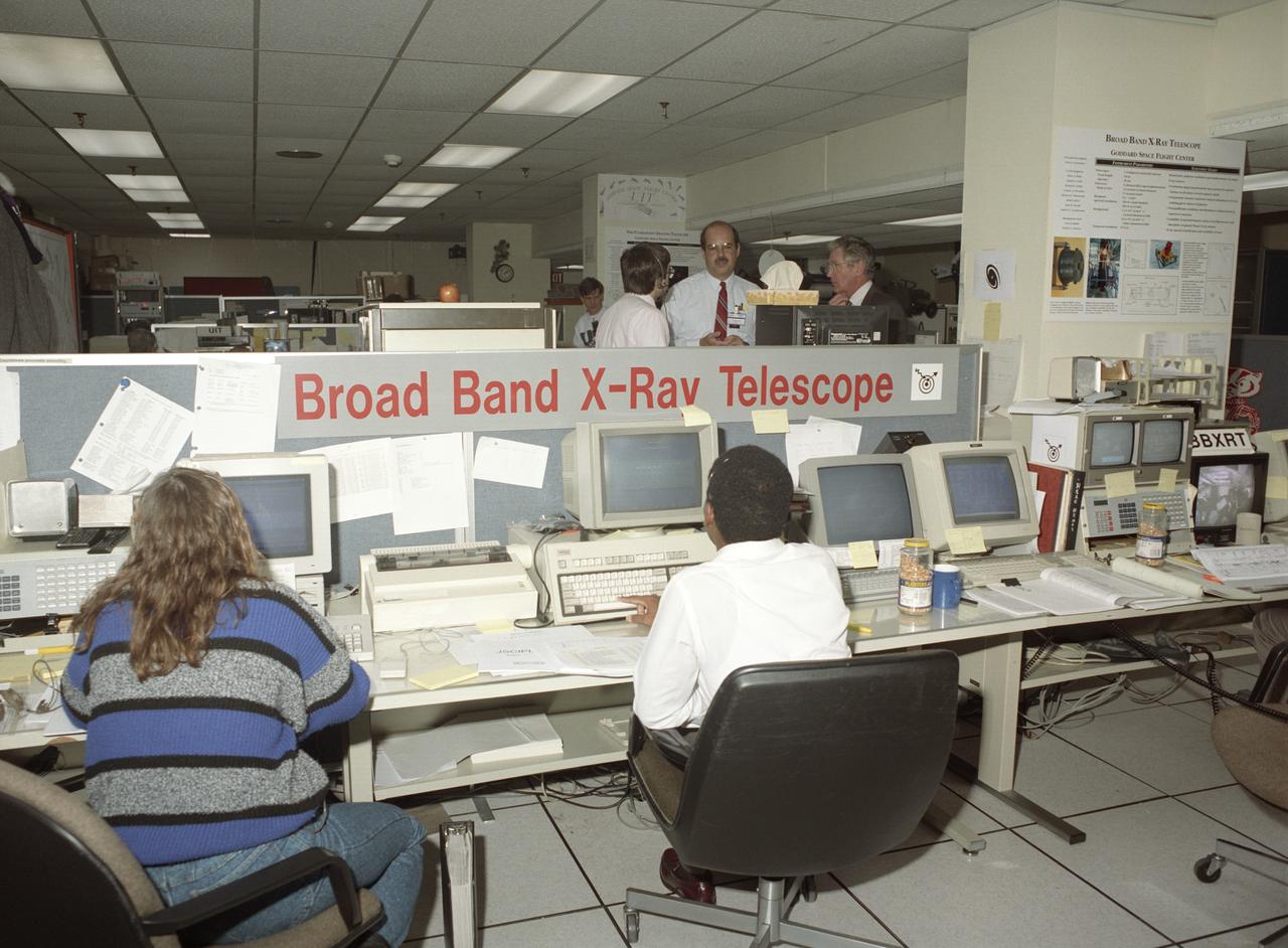 The primary objective of the STS-35 mission was round the clock observation of the celestial sphere in ultraviolet and X-Ray astronomy with the Astro-1 observatory which consisted of four telescopes: the Hopkins Ultraviolet Telescope (HUT); the Wisconsin Ultraviolet Photo-Polarimeter Experiment (WUPPE); the Ultraviolet Imaging Telescope (UIT); and the Broad Band X-Ray Telescope (BBXRT). The Huntsville Operations Support Center (HOSC) Spacelab Payload Operations Control Center (SL POCC) at the Marshall Space Flight Center (MSFC) was the air/ground communication channel used between the astronauts and ground control teams during the Spacelab missions. Teams of controllers and researchers directed on-orbit science operations, sent commands to the spacecraft, received data from experiments aboard the Space Shuttle, adjusted mission schedules to take advantage of unexpected science opportunities or unexpected results, and worked with crew members to resolve problems with their experiments.  Due to loss of data used for pointing and operating the ultraviolet telescopes, MSFC ground teams were forced to aim the telescopes with fine tuning by the flight crew. This photo captures the activity of WUPPE (Wisconsin Ultraviolet Photo-Polarimeter Experiment) data review at the Science Operations Area during the mission. This image shows mission activities at the Broad Band X-Ray Telescope (BBXRT) Work Station in the Science Operations Area (SOA). 
