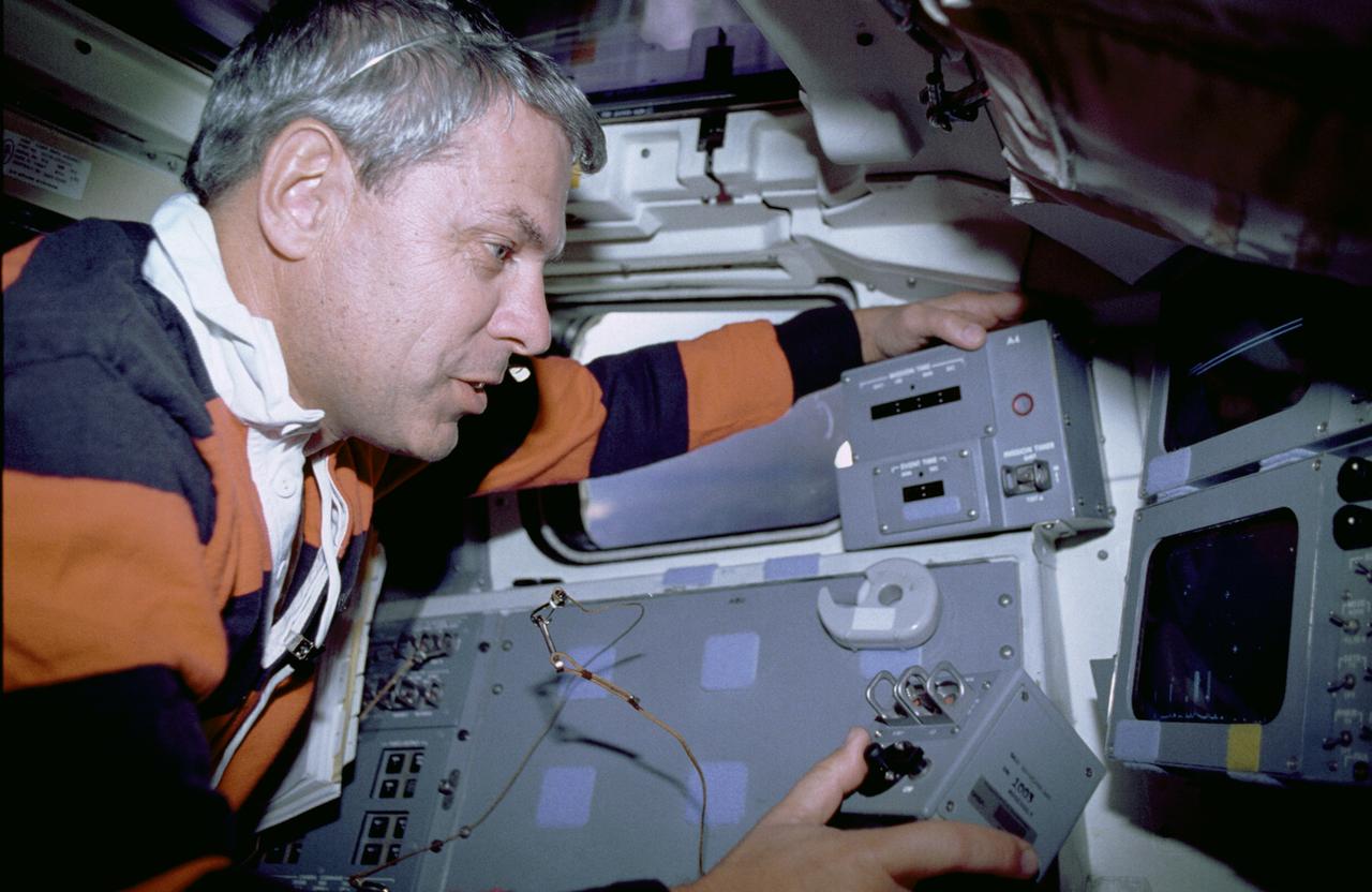 The primary objective of the STS-35 mission was round the clock observation of the celestial sphere in ultraviolet and X-Ray astronomy with the Astro-1 observatory which consisted of four telescopes: the Hopkins Ultraviolet Telescope (HUT); the Wisconsin Ultraviolet Photo-Polarimeter Experiment (WUPPE); the Ultraviolet Imaging Telescope (UIT); and the Broad Band X-Ray Telescope (BBXRT). The Huntsville Operations Support Center (HOSC) Spacelab Payload Operations Control Center (SL POCC) at the Marshall Space Flight Center (MSFC) was the air/ground communication channel used between the astronauts and ground control teams during the Spacelab missions. Teams of controllers and researchers directed on-orbit science operations, sent commands to the spacecraft, received data from experiments aboard the Space Shuttle, adjusted mission schedules to take advantage of unexpected science opportunities or unexpected results, and worked with crew members to resolve problems with their experiments. Due to loss of data used for pointing and operating the ultraviolet telescopes, MSFC ground teams were forced to aim the telescopes with fine tuning by the flight crew. Pictured onboard the shuttle is astronaut Robert Parker using a Manual Pointing Controller (MPC) for the ASTRO-1 mission Instrument Pointing System (IPS).